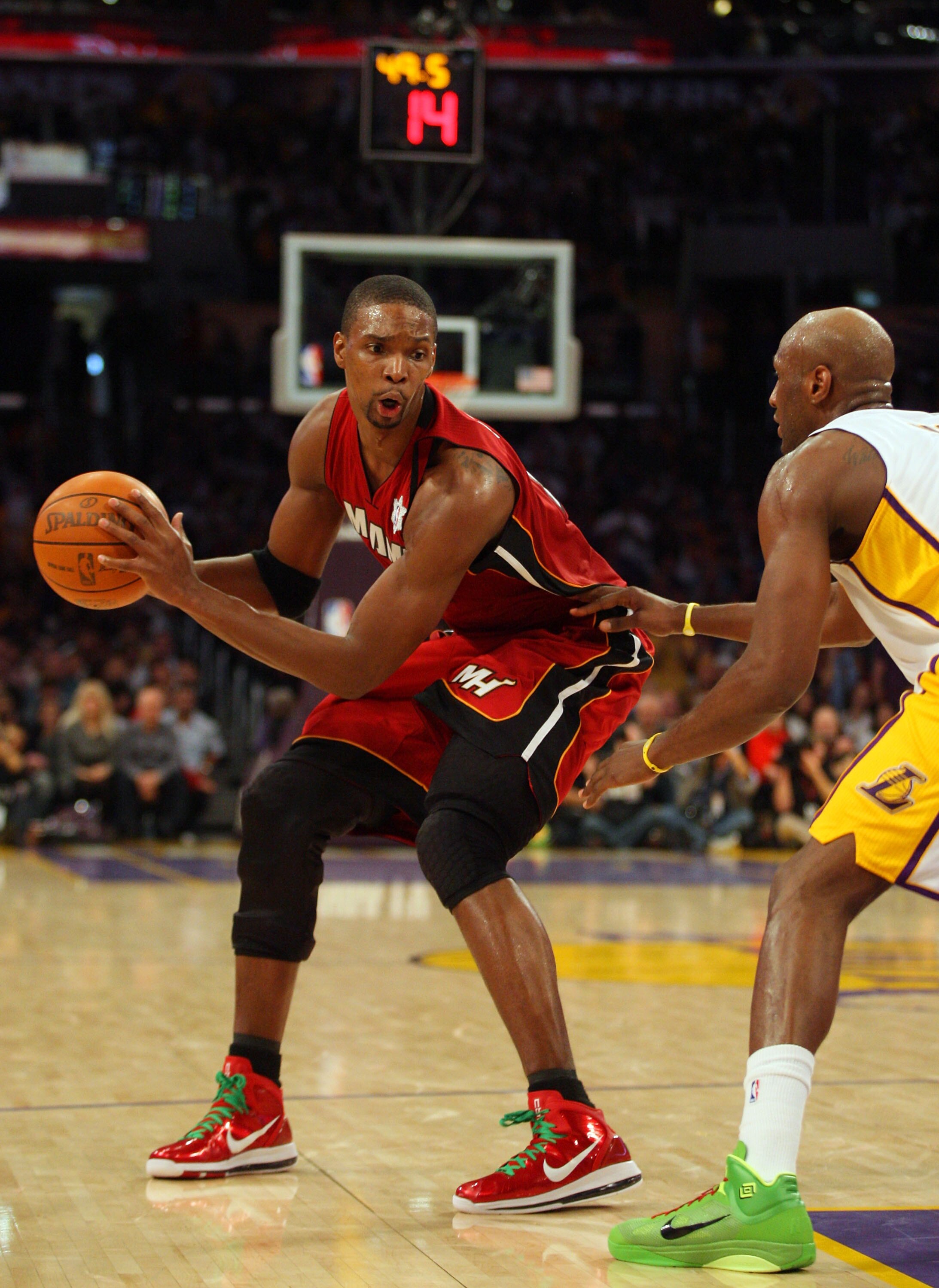 LOS ANGELES, CA - DECEMBER 25:  Chris Bosh #11 of the Miami Heat looks to make a move to the basket against Lamar Odom #7 of the Los Angeles Lakers during the NBA game at Staples Center on December 25, 2010 in Los Angeles, California. The Heat defeated th