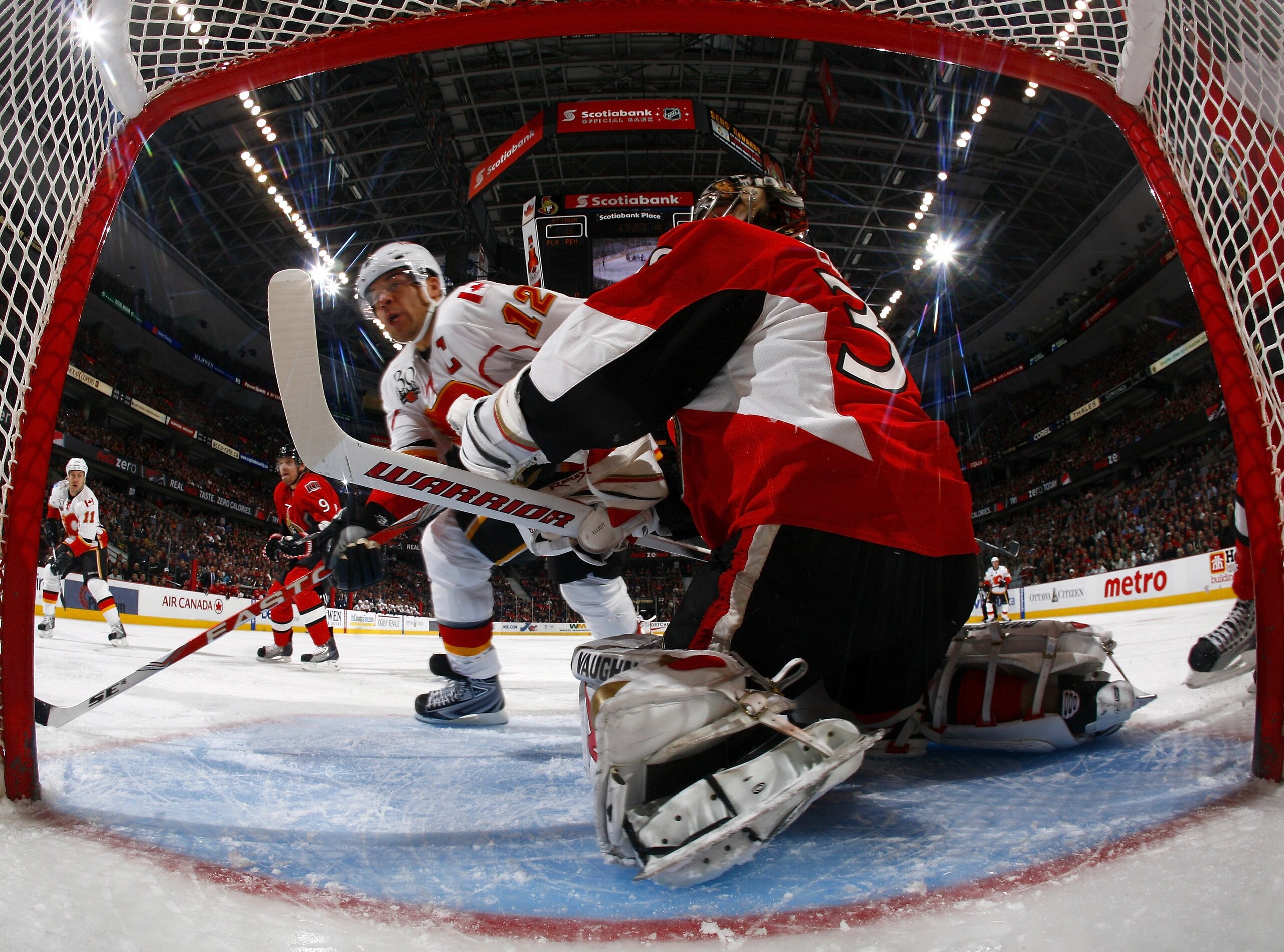OTTAWA, ON - FEBRUARY 09:  Jarome Iginla #12 of the Calgary Flames takes a shot against goaltender Brian Elliott #30 of the Ottawa Senators during the NHL game at Scotiabank Place on February 9, 2010 in Ottawa, Canada.  (Photo by Phillip MacCallum/Getty I
