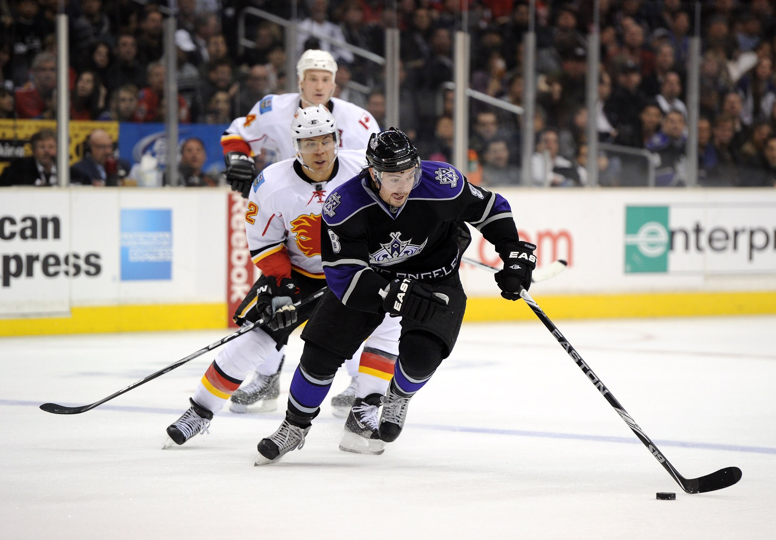 LOS ANGELES, CA - DECEMBER 09:  Drew Doughty #8 of the Los Angeles Kings skates in past Jerome Iginla #12 of the Calgary Flames at the Staples Center on December 9, 2010 in Los Angeles, California.  (Photo by Harry How/Getty Images)