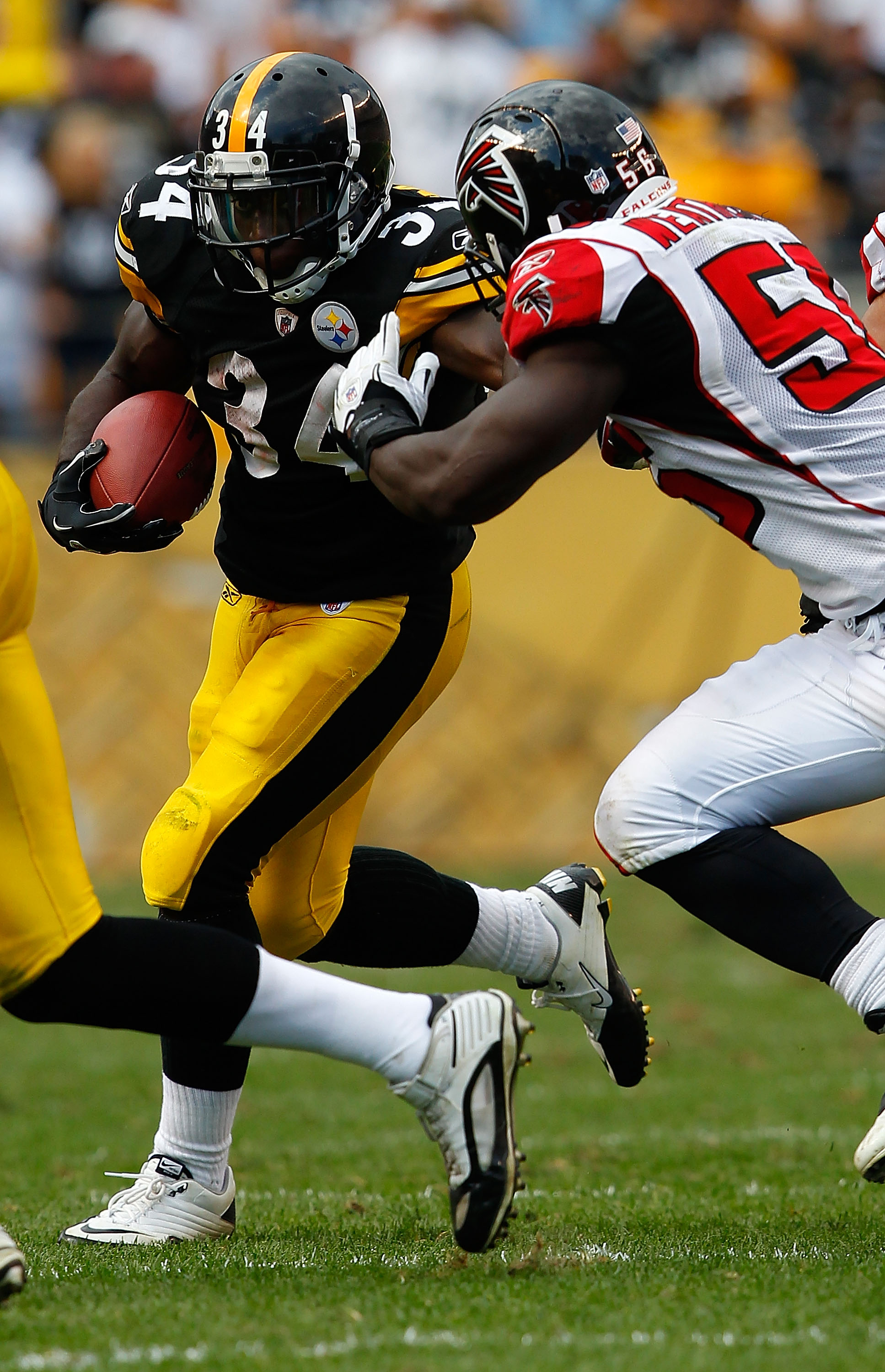 PITTSBURGH - SEPTEMBER 12:  Rashard Mendenhall #34 of the Pittsburgh Steelers attempts to run through Sean Weatherspoon #56 of the Atlanta Falcons during the NFL season opener game on September 12, 2010 at Heinz Field in Pittsburgh, Pennsylvania.  (Photo