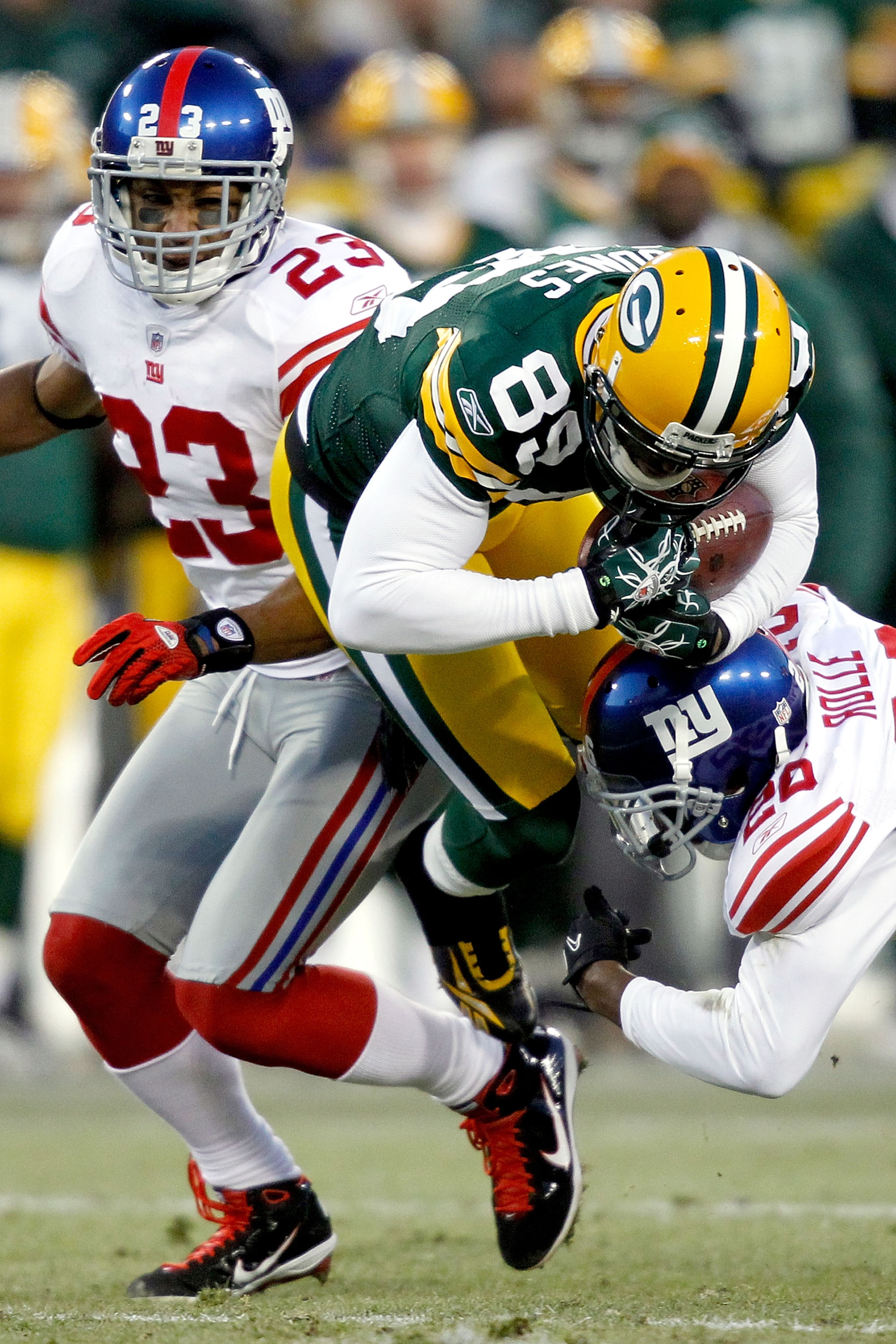 GREEN BAY, WI - DECEMBER 26:  James Jones #89 of the Green Bay Packers is tackled by Antrel Rolle #26 of the New York Giants at Lambeau Field on December 26, 2010 in Green Bay, Wisconsin.  (Photo by Matthew Stockman/Getty Images)