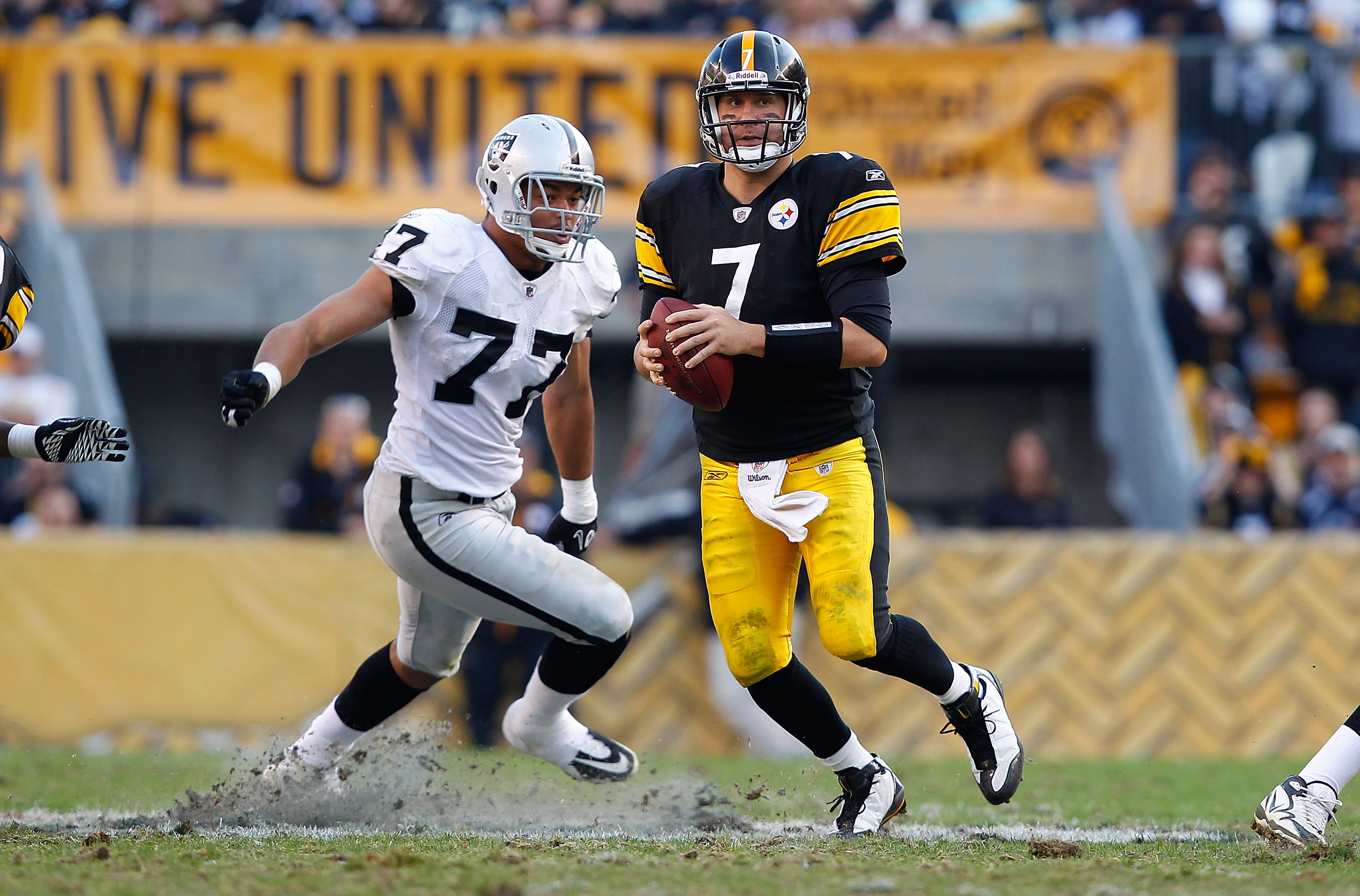 PITTSBURGH, PA - NOVEMBER 21:  Ben Roethlisberger #7 of the Pittsburgh Steelers runs out of the pocket from Matt Shaughnessy #77 of the Oakland Raiders during the game on November 21, 2010 at Heinz Field in Pittsburgh, Pennsylvania.  (Photo by Jared Wicke