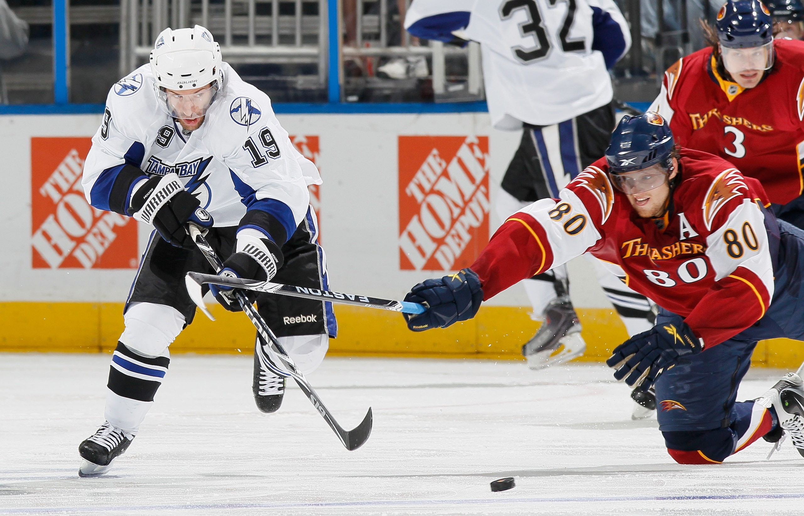 ATLANTA - OCTOBER 22:  Dominic Moore #19 of the Tampa Bay Lightning battles for the puck against Nik Antropov #80 of the Atlanta Thrashers at Philips Arena on October 22, 2010 in Atlanta, Georgia.  (Photo by Kevin C. Cox/Getty Images)