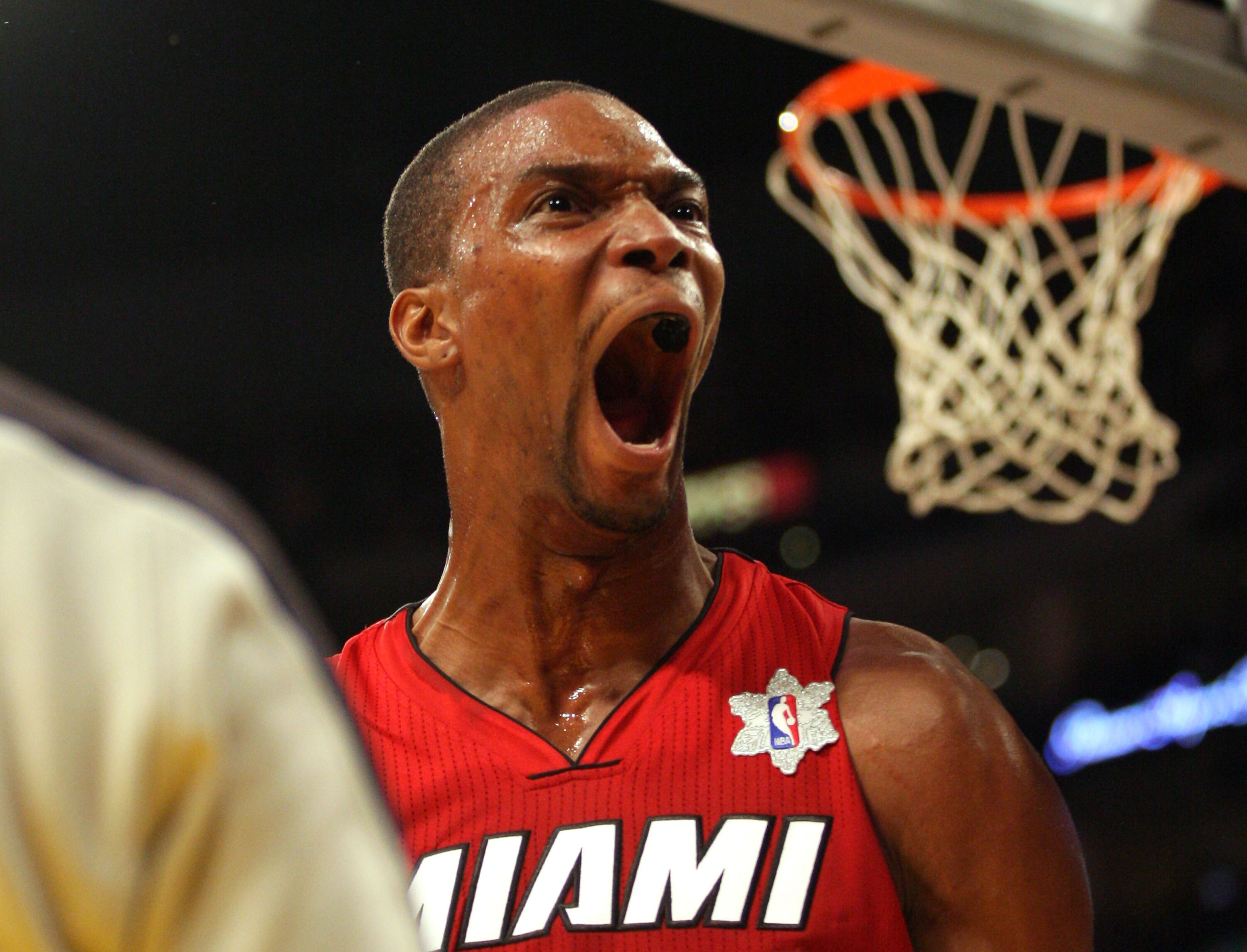 LOS ANGELES, CA - DECEMBER 25:  Chris Bosh #1 of the Miami Heat reacts after making a basket against the Los Angeles Lakers during the NBA game at Staples Center on December 25, 2010 in Los Angeles, California.  The Heat defeated the Lakers 96-80. NOTE TO