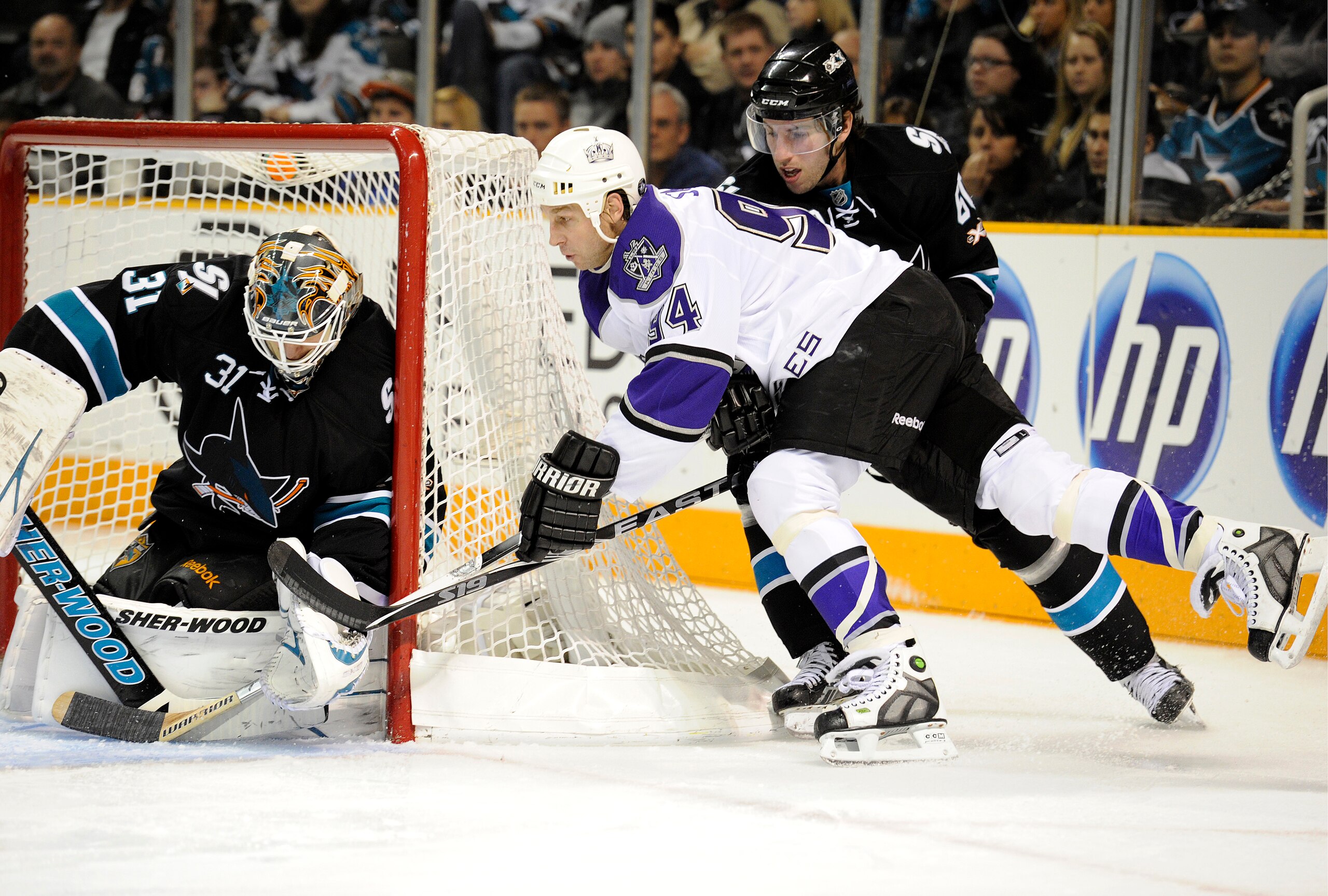 SAN JOSE, CA - DECEMBER 27: Ryan Smyth #94 of the Los Angeles Kings cant stuff the puck pass goalie Antti Niemi #31 of the San Jose Sharks during an NHL hockey game at the HP Pavilion on December 27, 2010 in San Jose, California. The Kings won the game 4-
