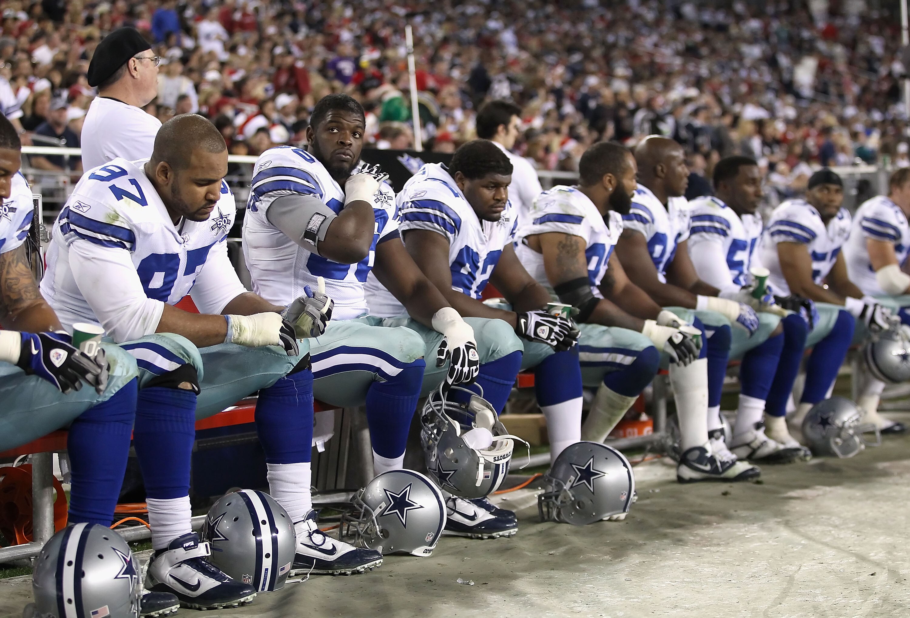 GLENDALE, AZ - DECEMBER 25:  (2nd from left) Clifton Geathers #66 of the Dallas Cowboys looks up from the bench during the NFL game against the Arizona Cardinals at the University of Phoenix Stadium on December 25, 2010 in Glendale, Arizona. The Cardinals