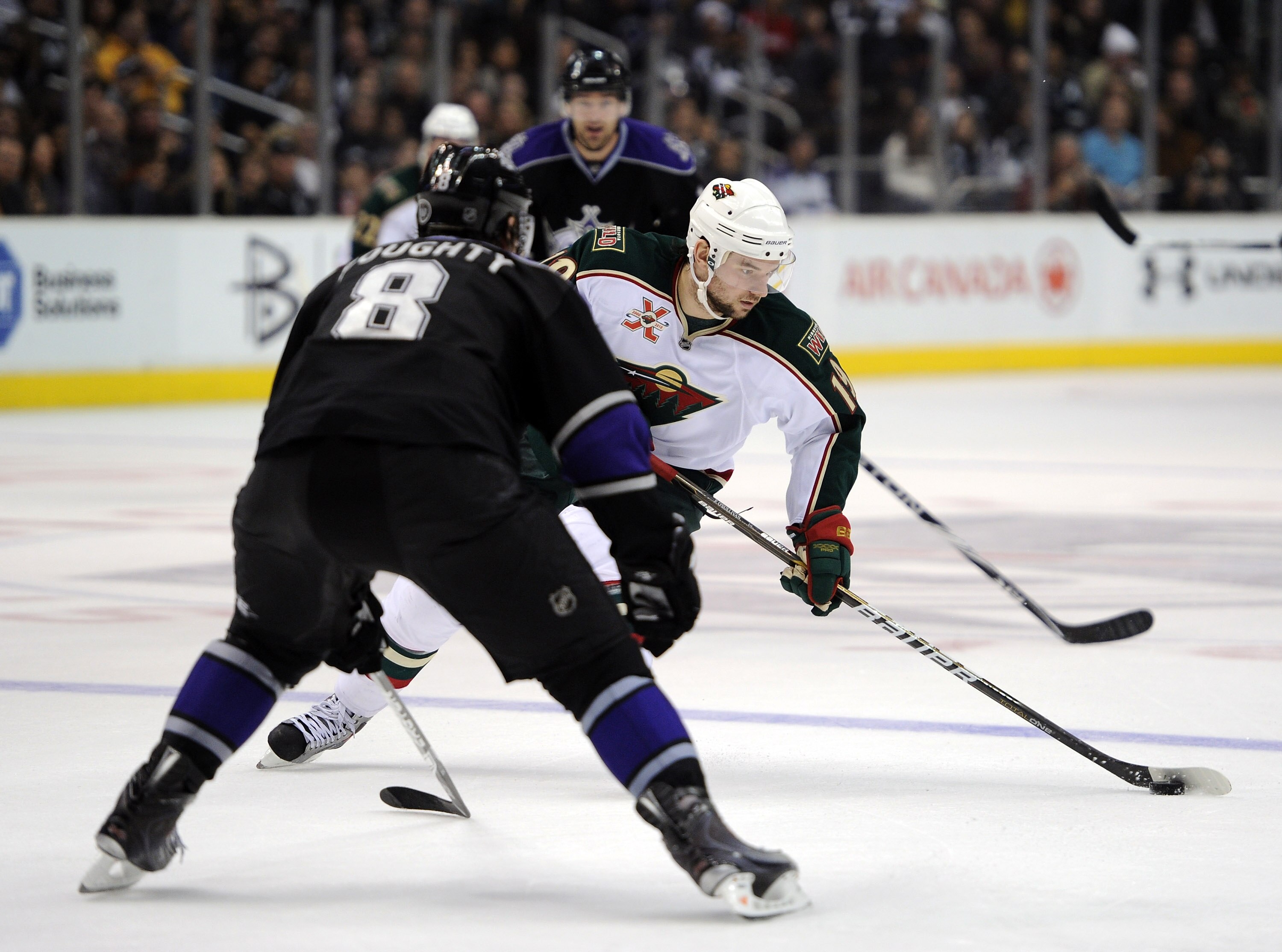 LOS ANGELES, CA - DECEMBER 11:  Patrick O'Sullivan #19 of the Minnesota Wild breaks in on Drew Doughty #8 of the Los Angeles Kings at the Staples Center on December 11, 2010 in Los Angeles, California.  (Photo by Harry How/Getty Images)