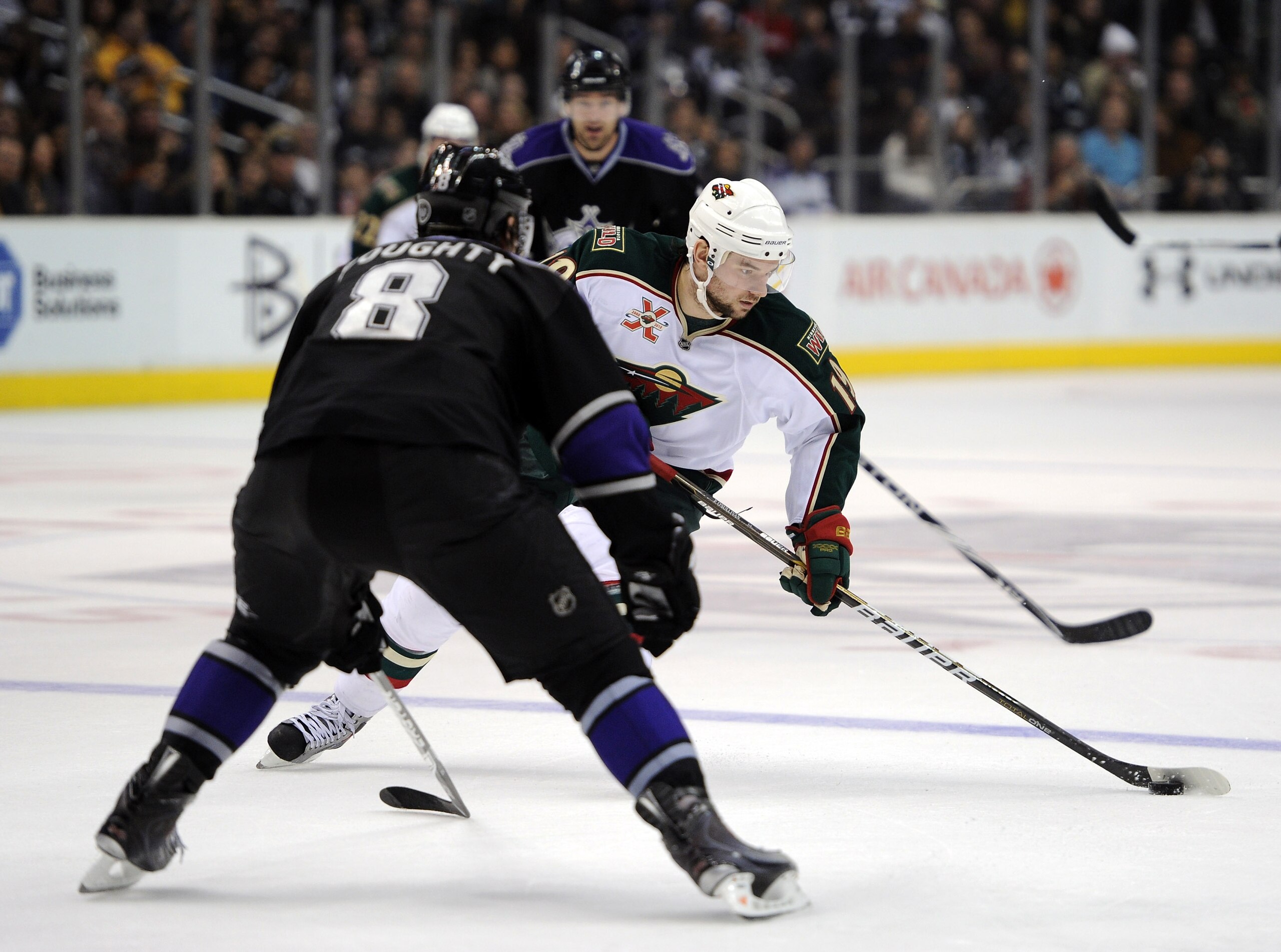 LOS ANGELES, CA - DECEMBER 11:  Patrick O'Sullivan #19 of the Minnesota Wild breaks in on Drew Doughty #8 of the Los Angeles Kings at the Staples Center on December 11, 2010 in Los Angeles, California.  (Photo by Harry How/Getty Images)