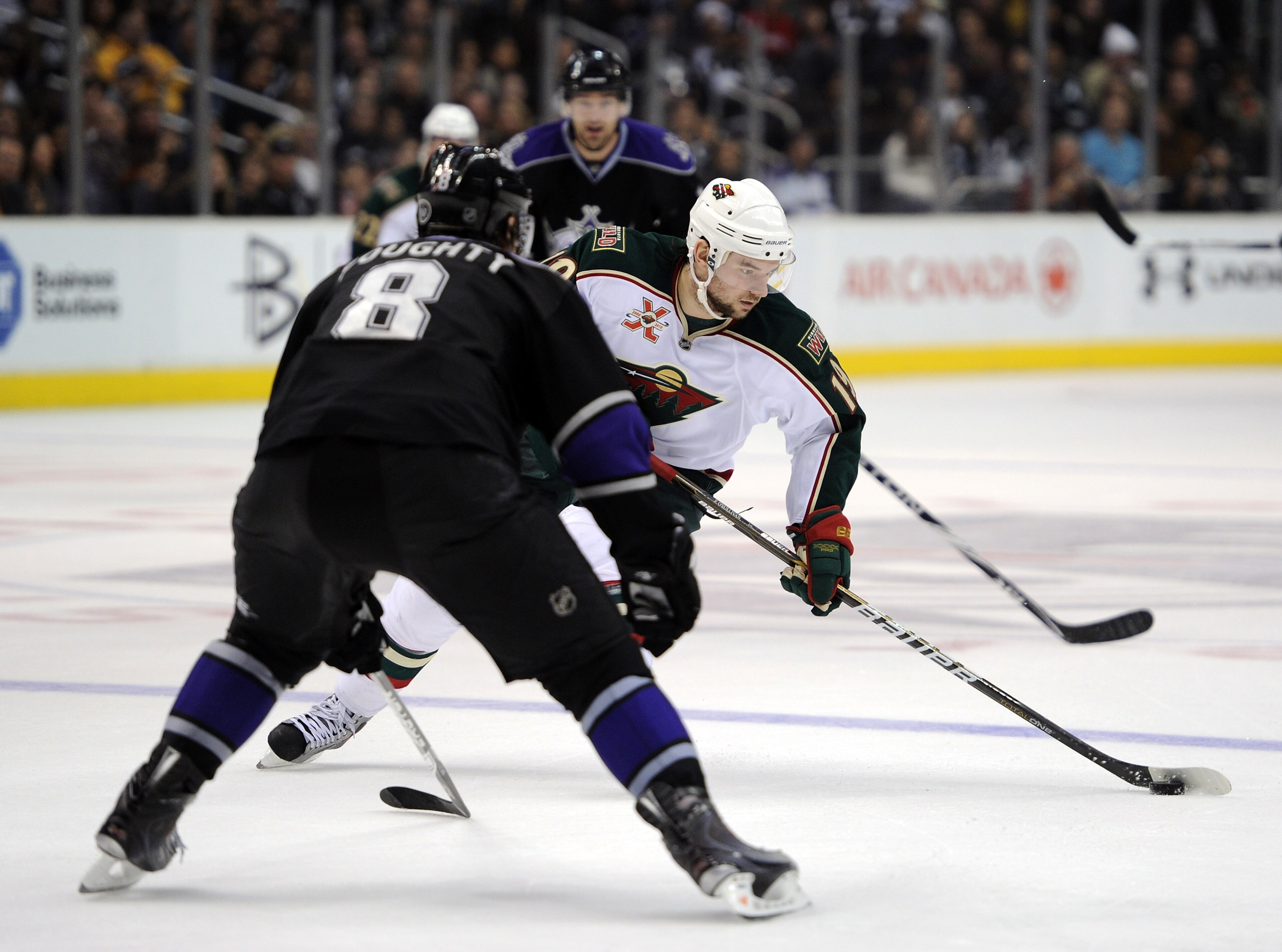 LOS ANGELES, CA - DECEMBER 11:  Patrick O'Sullivan #19 of the Minnesota Wild breaks in on Drew Doughty #8 of the Los Angeles Kings at the Staples Center on December 11, 2010 in Los Angeles, California.  (Photo by Harry How/Getty Images)