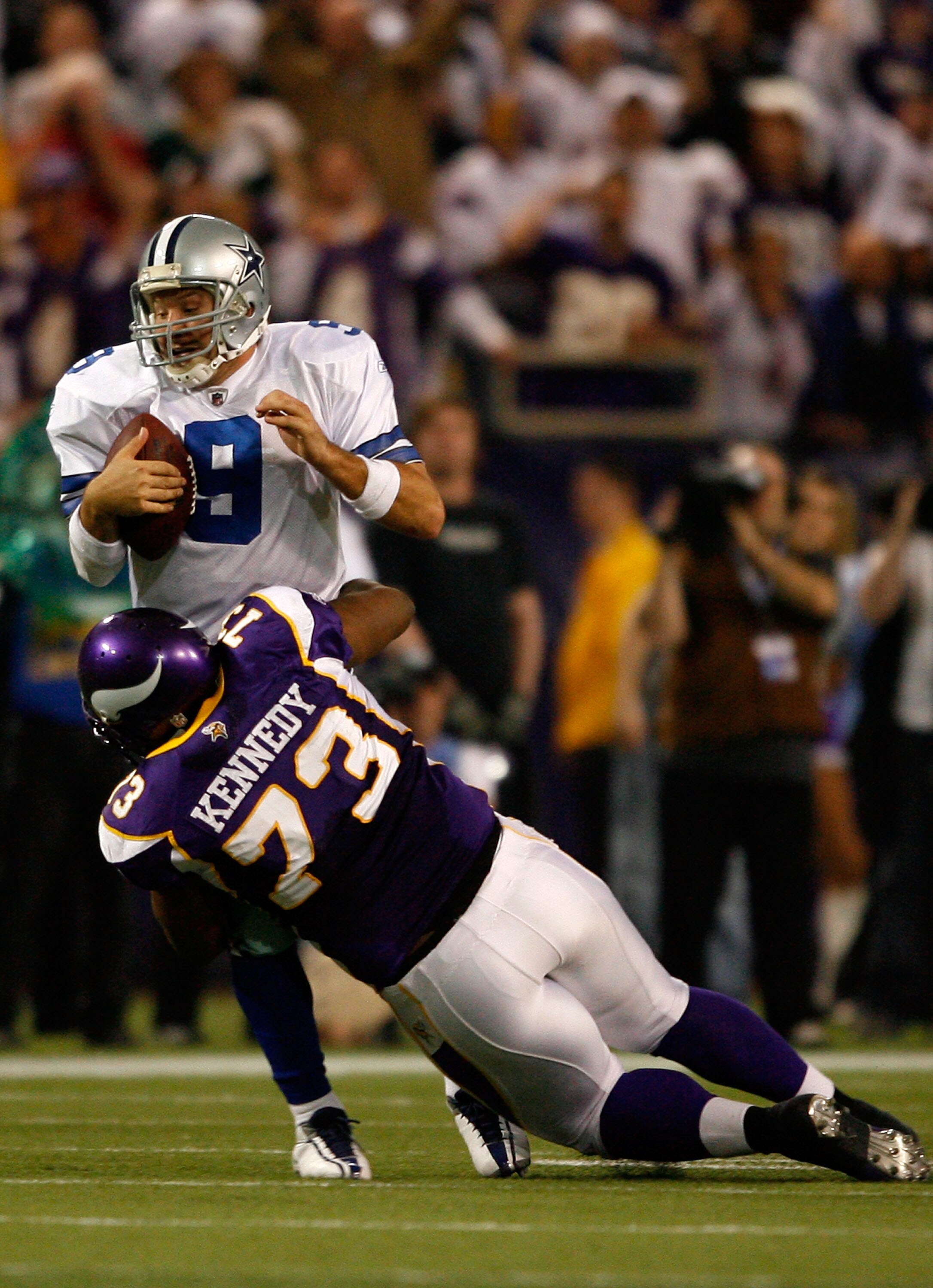 MINNEAPOLIS - JANUARY 17:  Tony Romo #9 of the Dallas Cowboys is sacked by Jimmy Kennedy #73 of the Minnesota Vikings during fourth quarter of the NFC Divisional Playoff Game at Hubert H. Humphrey Metrodome on January 17, 2010 in Minneapolis, Minnesota. T