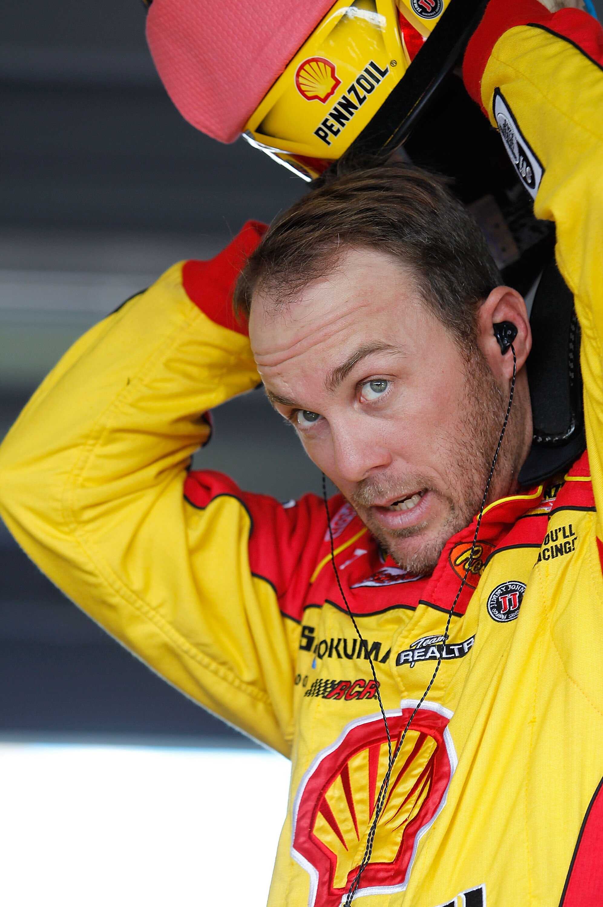 HOMESTEAD, FL - NOVEMBER 19:  Kevin Harvick, driver of the #29 Shell/Pennzoil Chevrolet, stands in the garage prior to practice for the NASCAR Sprint Cup Series Ford 400 at Homestead-Miami Speedway on November 19, 2010 in Homestead, Florida.  (Photo by To