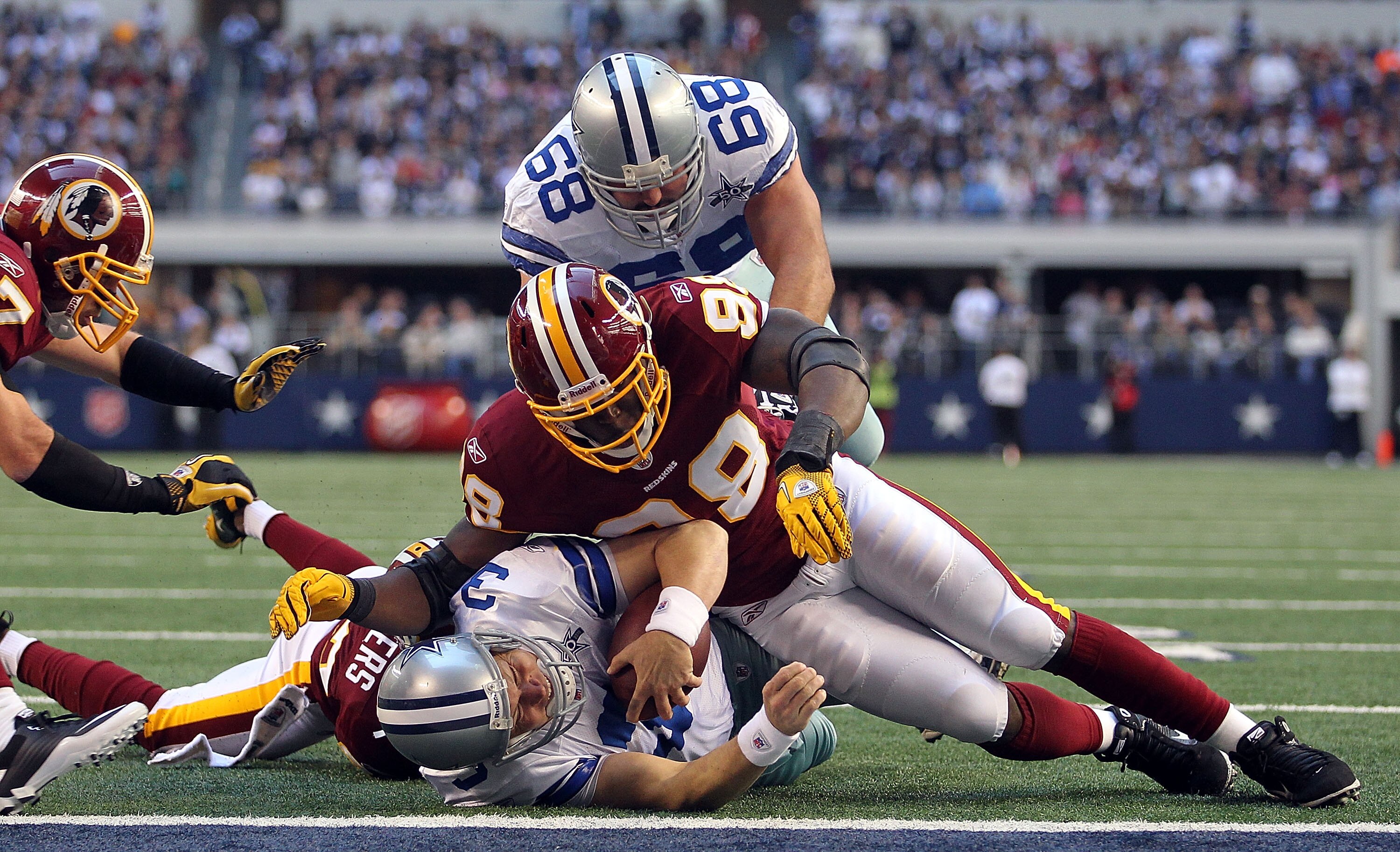 ARLINGTON, TX - DECEMBER 19:  Quarterback Jon Kitna #3 of the Dallas Cowboys is tackled at the one yard line by Brian Orakpo #98 of the Washington Redskins at Cowboys Stadium on December 19, 2010 in Arlington, Texas.  (Photo by Ronald Martinez/Getty Image