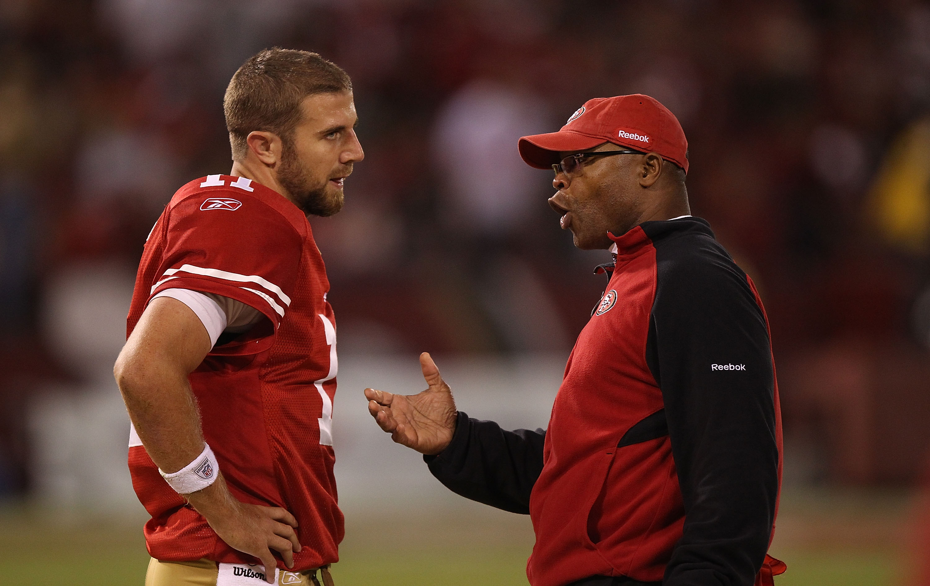SAN FRANCISCO - OCTOBER 10:  Head coach Mike Singletary of the San Francisco 49ers talks with quarterback Alex Smith #11 against the Philadelphia Eagles during an NFL game at Candlestick Park on October 10, 2010 in San Francisco, California.  (Photo by Je