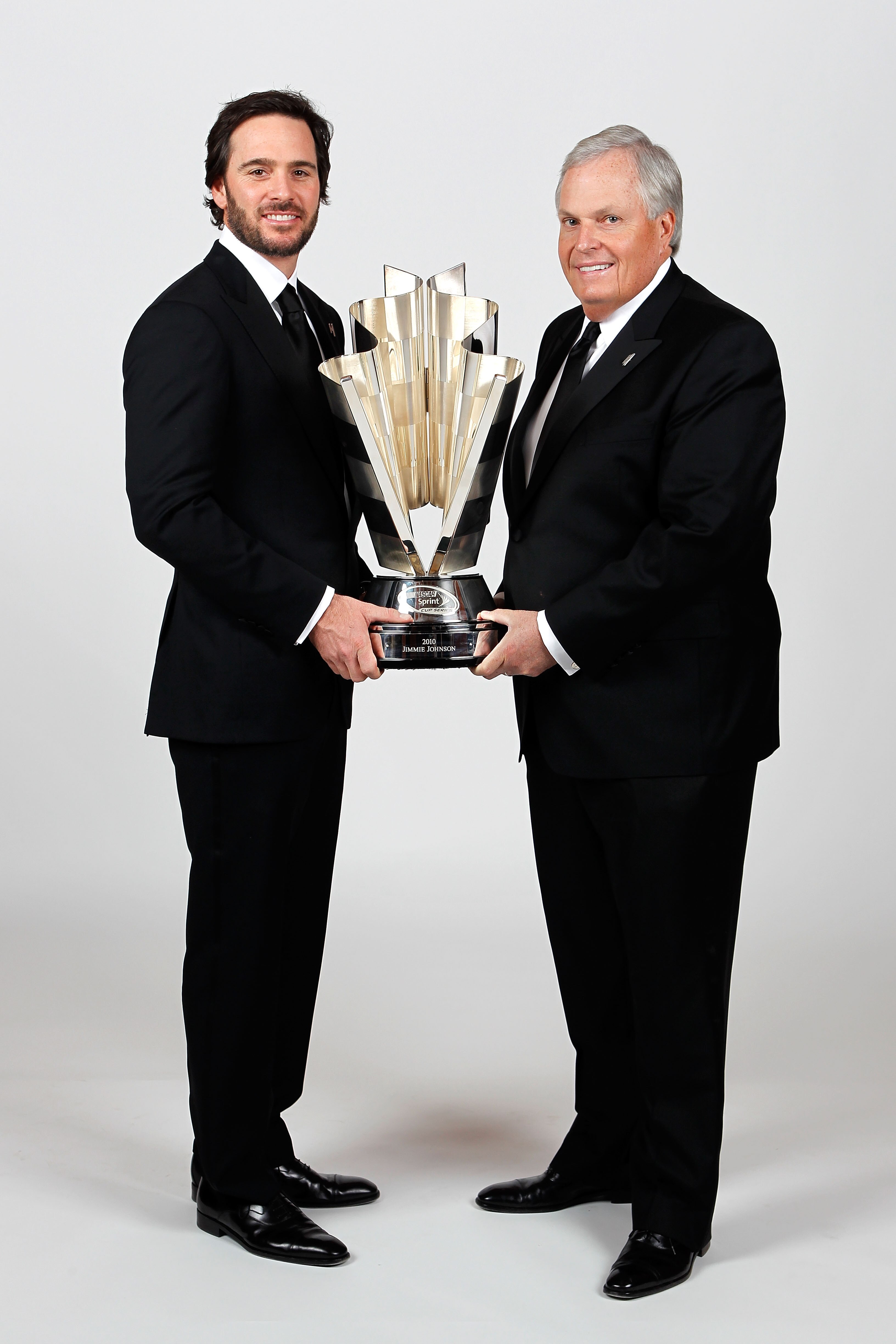 LAS VEGAS, NV - DECEMBER 03:  (L-R) Five-time champion Jimmie Johnson poses with team owner Rick Hendrick and the Sprint Cup trophy during the NASCAR Sprint Cup Series awards banquet at the Wynn Las Vegas Hotel on December 3, 2010 in Las Vegas, Nevada.  (