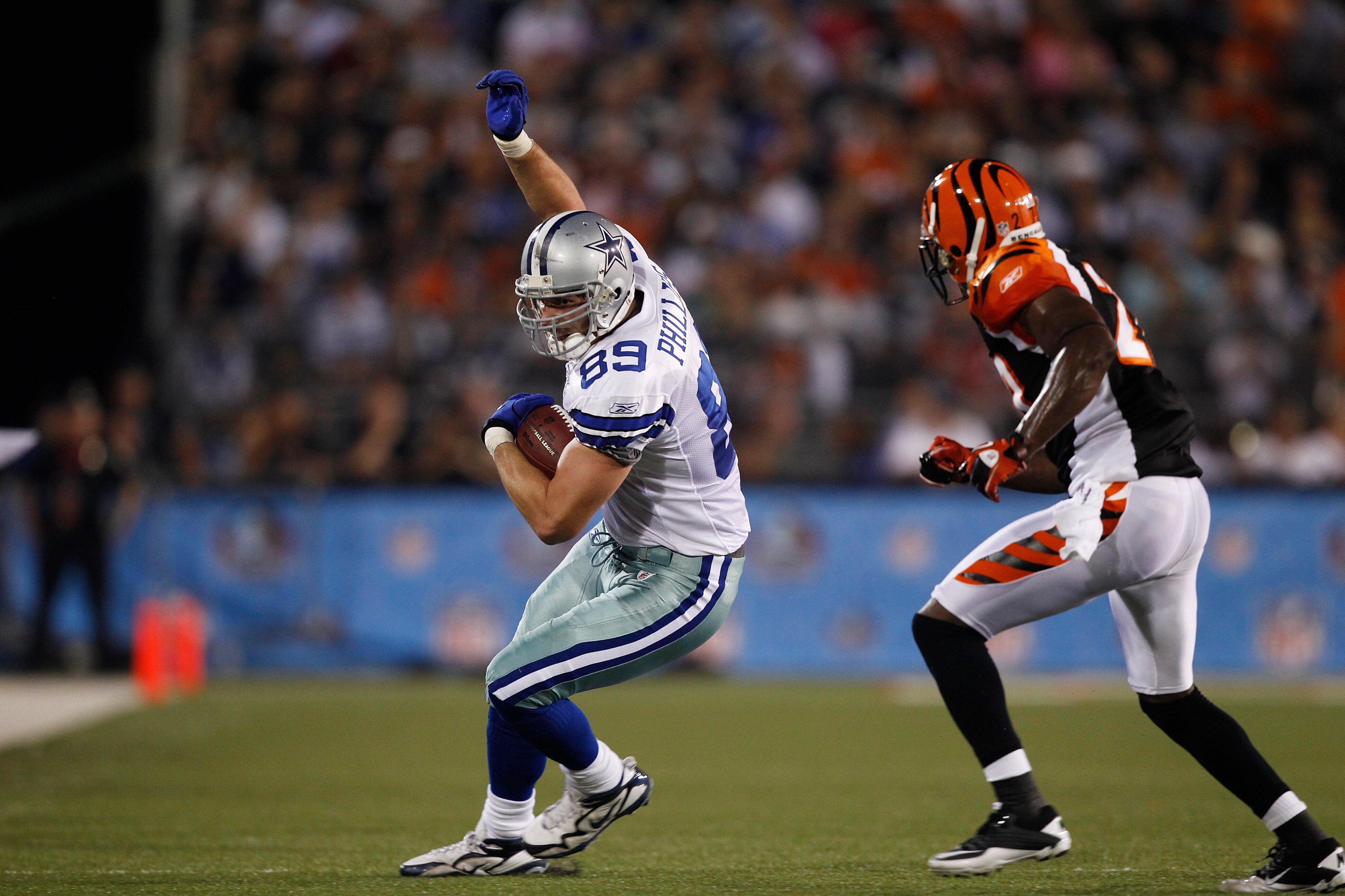 CANTON, OH - AUGUST 8: John Phillips #89 of the Dallas Cowboys runs with the football after catching a pass against the Cincinnati Bengals during the 2010 Pro Football Hall of Fame Game at the Pro Football Hall of Fame Field at Fawcett Stadium on August 8