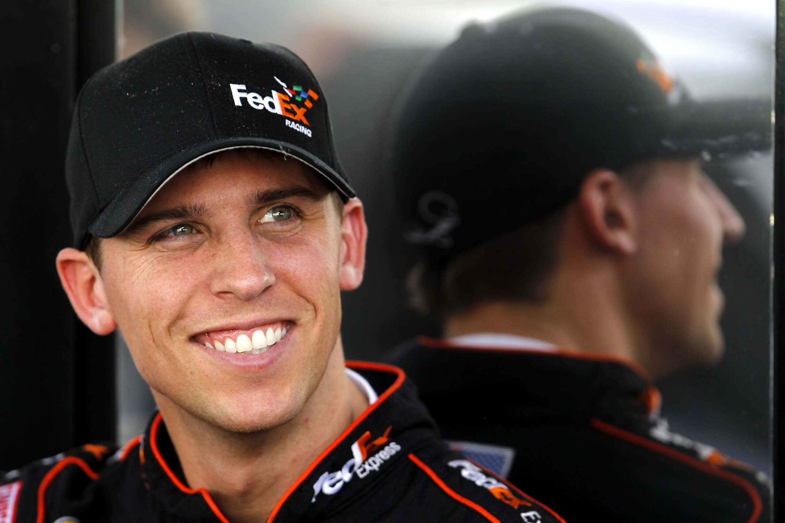 HOMESTEAD, FL - NOVEMBER 19: Denny Hamlin, driver of the #11 FedEx Toyota, sits by his team hauler in the garage area during practice for the NASCAR Sprint Cup Series Ford 400 at Homestead-Miami Speedway on November 19, 2010 in Homestead, Florida. (Phot HOMESTEAD, FL - NOVEMBER 19: Denny Hamlin, driver of the #11 FedEx Toyota, sits by his team hauler in the garage area during practice for the NASCAR Sprint Cup Series Ford 400 at Homestead-Miami Speedway on November 19, 2010 in Homestead, Florida. (Phot