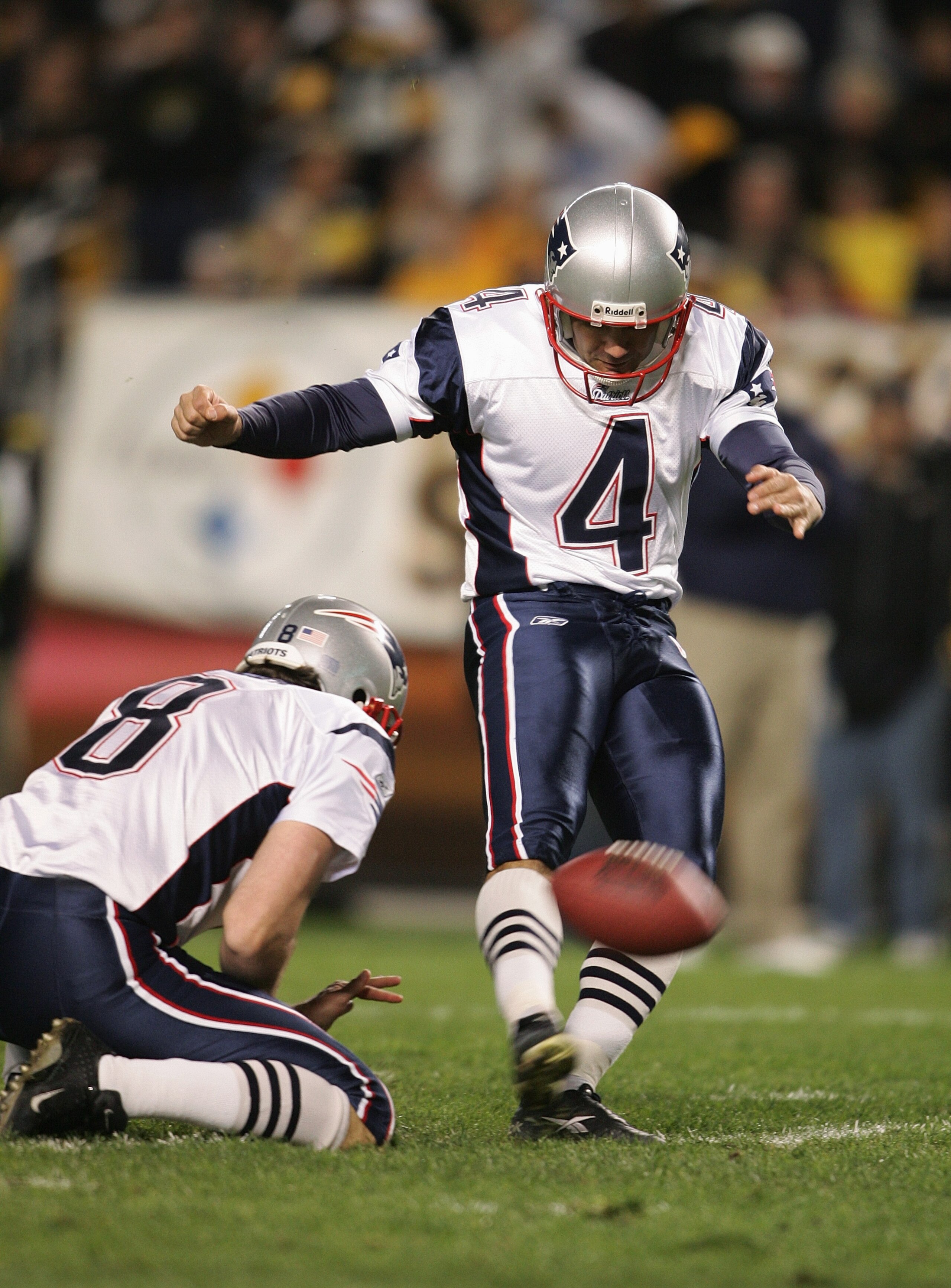 PITTSBURGH - OCTOBER 31:  Kicker Adam Vinatieri #4 of the New England Patriots attempts to score off a hold by punter Josh Miller #8 during the game against the Pittsburgh Steelers at Heinz Field on October 31, 2004 in Pittsburgh, Pennsylvania. The Steele