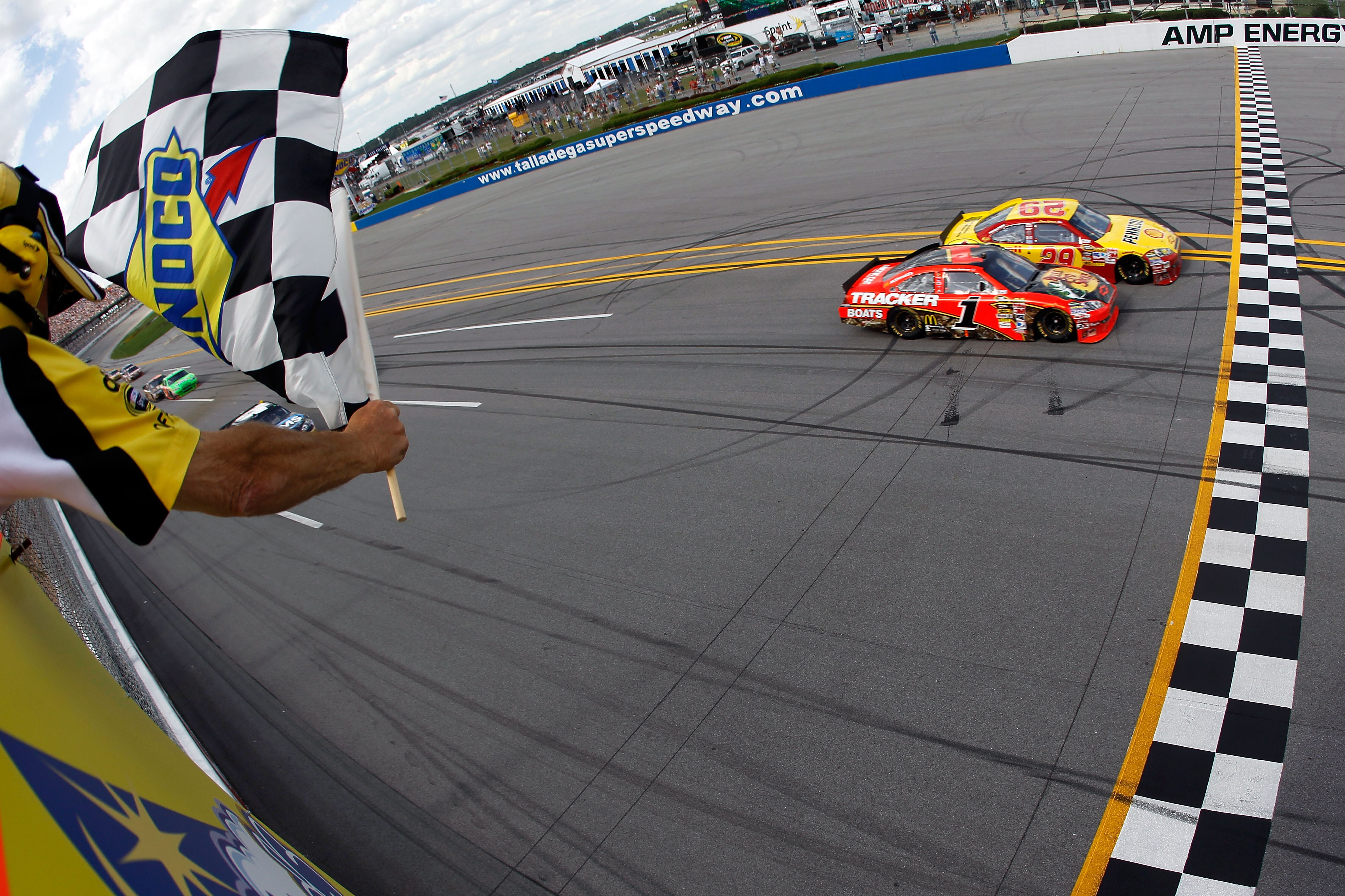 TALLADEGA, AL - APRIL 25:  Kevin Harvick, driver of the #29 Shell/Pennzoil Chevrolet, crosses the finish line ahead of Jamie McMurray, driver of the #1 Bass Pro Shops Chevrolet, to win the NASCAR Sprint Cup Series Aaron's 499 at Talladega Superspeedway on