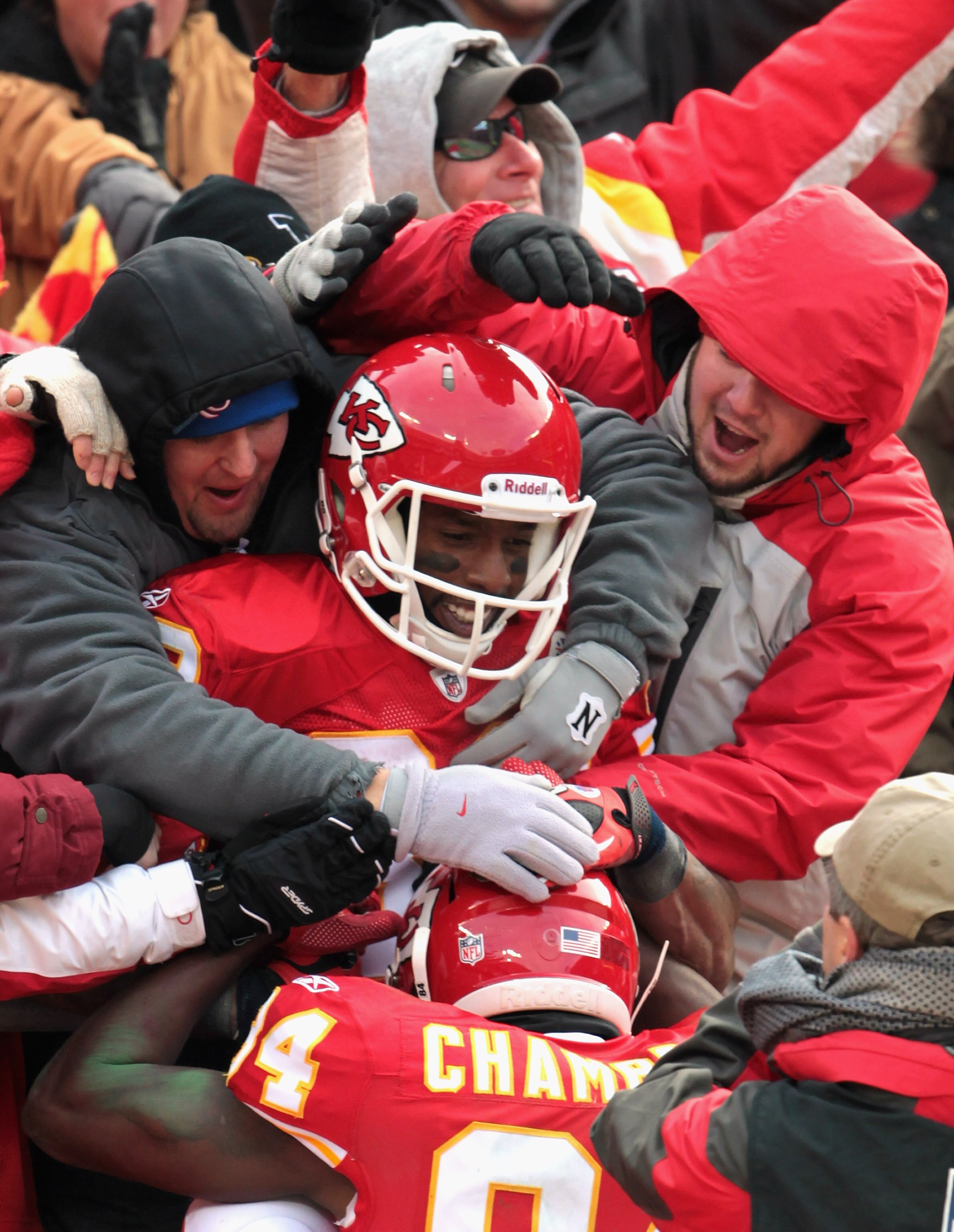 KANSAS CITY, MO - DECEMBER 26:  Receiver Dwayne Bowe #82 of the Kansas City Chiefs is congratulated by Chris Chambers #84 and fans as he jumps into the stands after making a 75 yard touchdown catch during the game against the Tennessee Titans on December