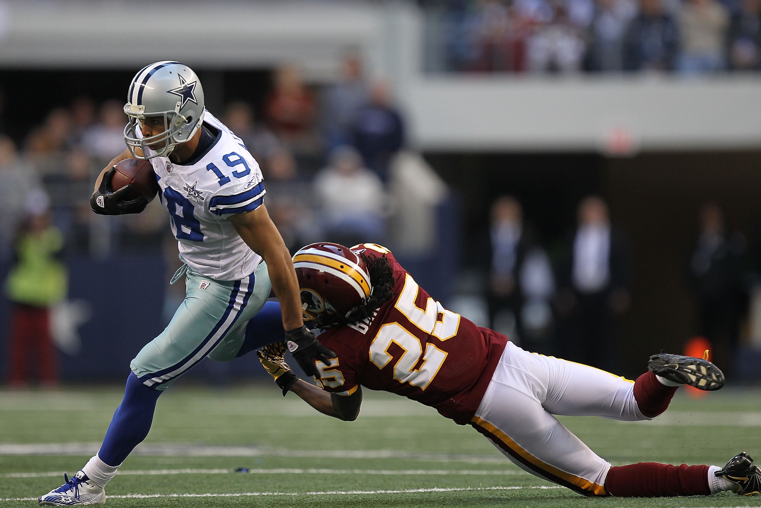ARLINGTON, TX - DECEMBER 19:  Wide receiver Miles Austin #19 of the Dallas Cowboys runs the ball against Kevin Barnes #25 of the Washington Redskins at Cowboys Stadium on December 19, 2010 in Arlington, Texas.  (Photo by Ronald Martinez/Getty Images)
