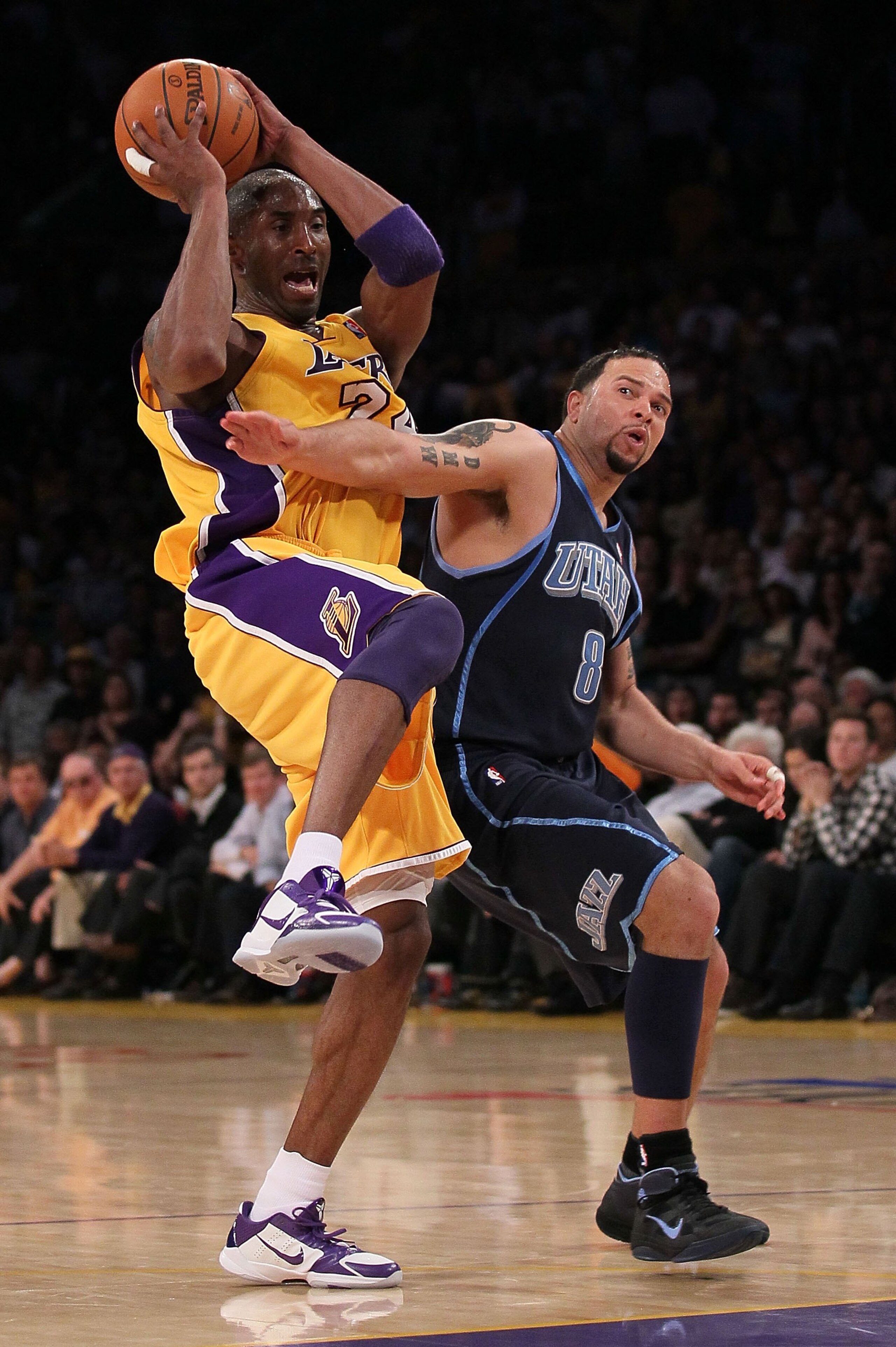 LOS ANGELES, CA - MAY 04:  Kobe Bryant #24 of the Los Angeles Lakers gets tied up with Deron Williams #8 of the Utah Jazz in the fourth quarter during Game Two of the Western Conference Semifinals of the 2010 NBA Playoffs at Staples Center on May 4, 2010