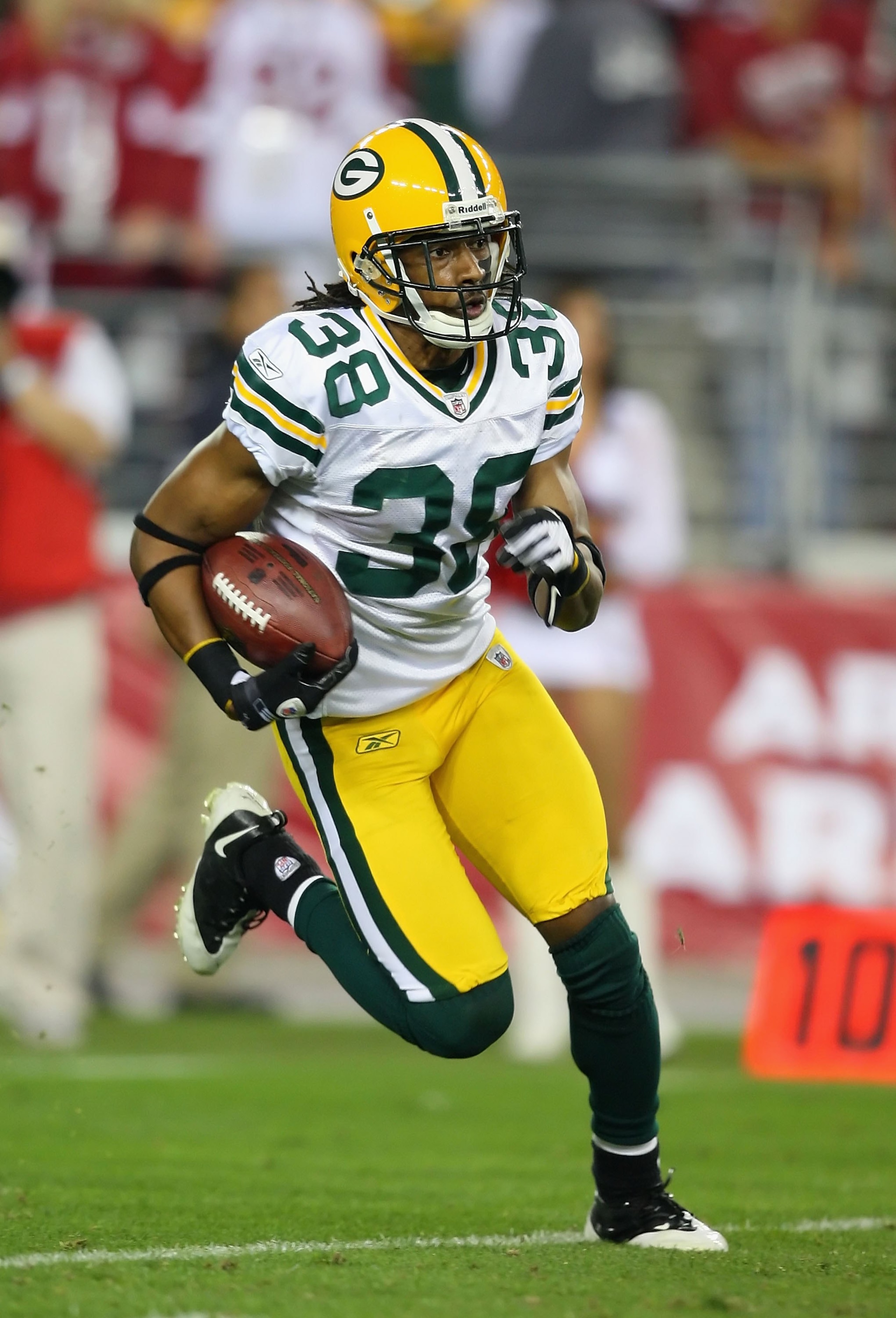 GLENDALE, AZ - JANUARY 10:  Cornerback Tramon Williams #38 of the Green Bay Packers returns a kick off during the 2010 NFC wild-card playoff game against the Arizona Cardinals at the Universtity of Phoenix Stadium on January 10, 2010 in Glendale, Arizona.