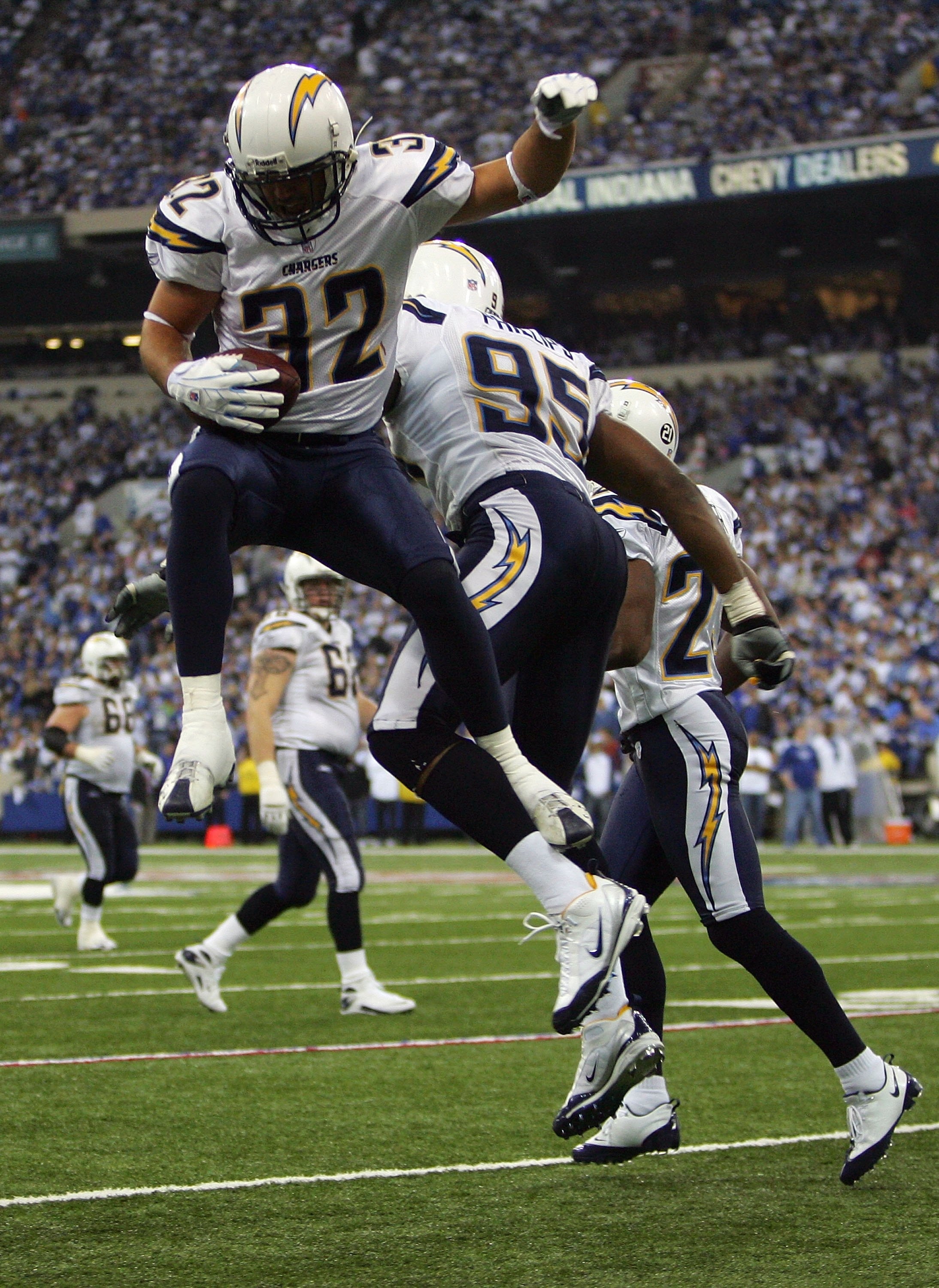 INDIANAPOLIS - JANUARY 13:  Eric Weddle #32 and Shaun Phillips #95 of the San Diego Chargers bump in the air as they celebrate after Weddle intercepted a pass in the third quarter against the Indianapolis Colts during their AFC Divisional Playoff game at