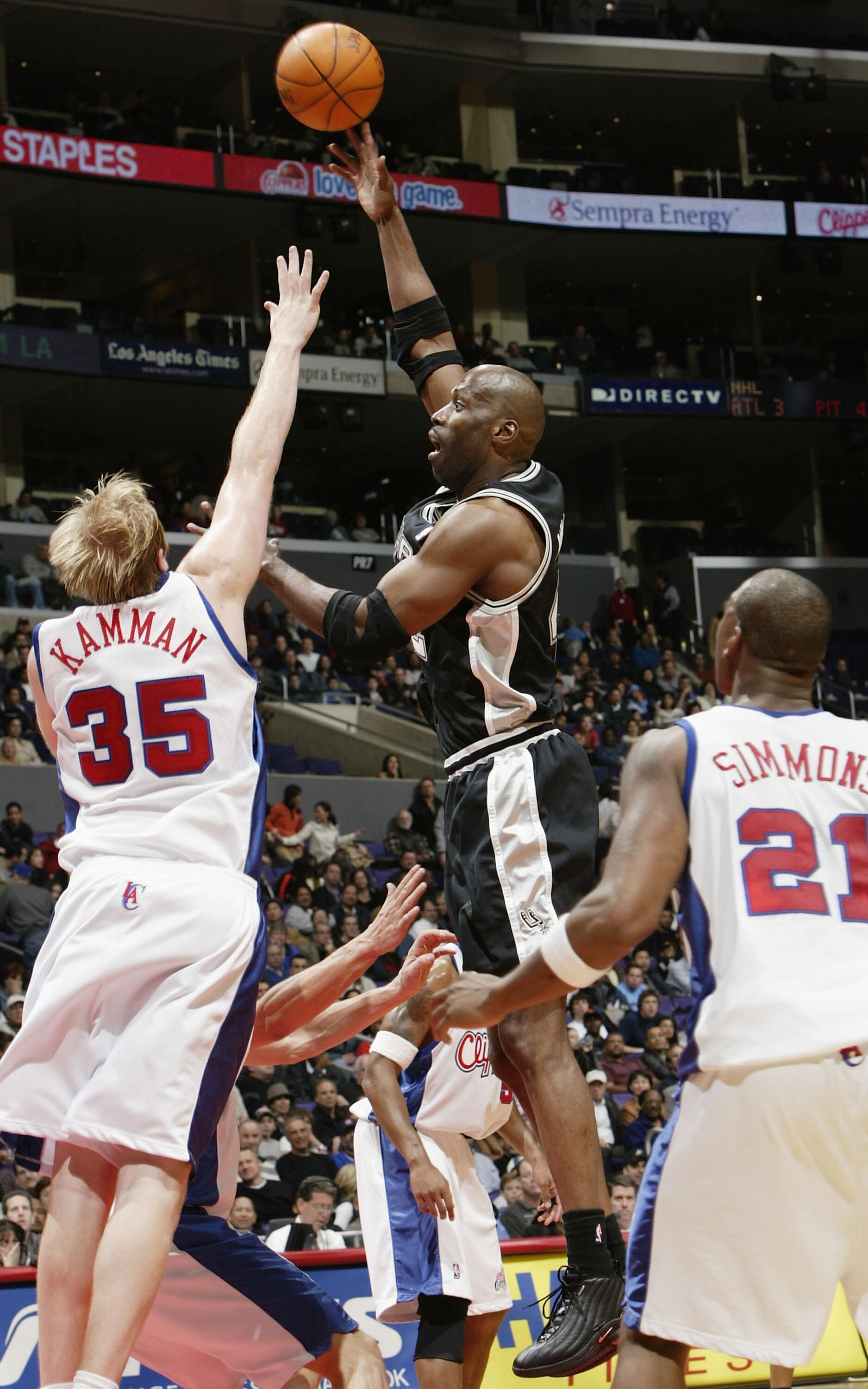 LOS ANGELES - DECEMBER 1:  Kevin Willis #42 of the San Antonio Spurs takes a shot between Chris Kaman #35 and Bobby Simmons #21 of the Los Angeles Clippers on December 1, 2003 at Staples Center in Los Angeles, California. NOTE TO USER: User expressly ackn