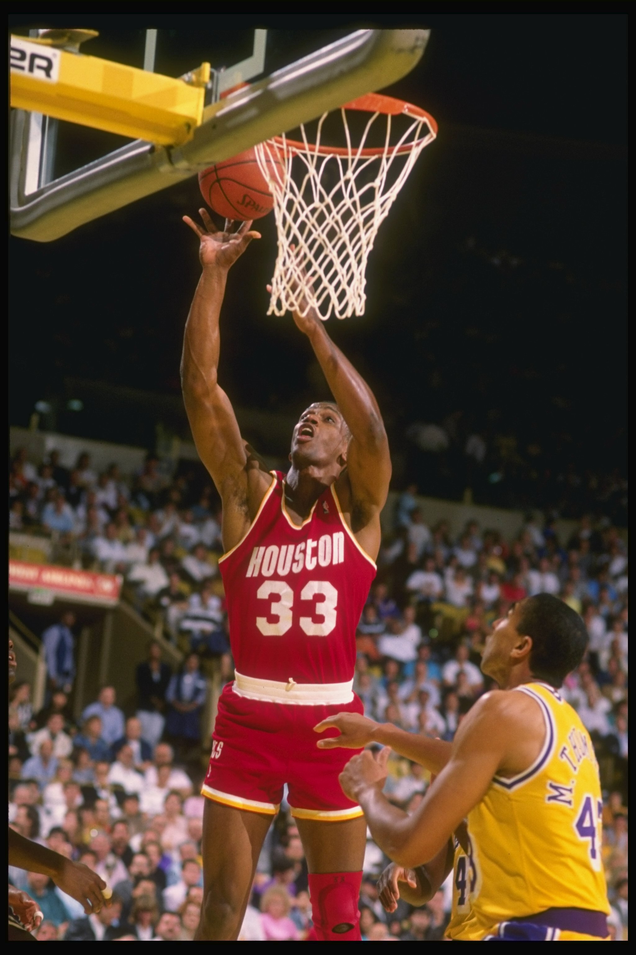 Forward Otis Thorpe of the Houston Rockets (left) goes up for two during a game against the Los Angeles Lakers at the Great Western Forum in Inglewood, California.