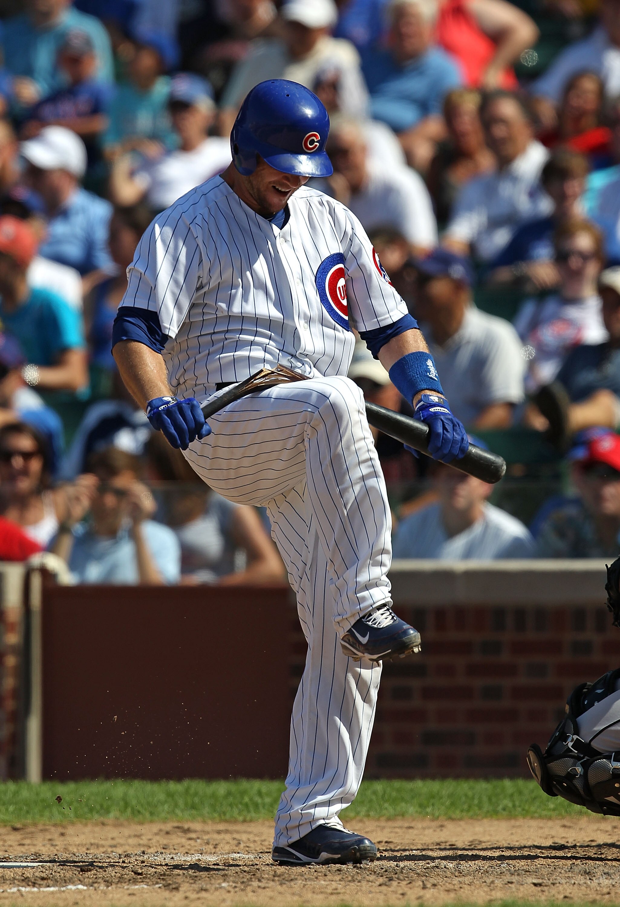 CHICAGO - JULY 21: Koyie Hill #55 of the Chicago Cubs breaks his bat over his knee after striking out trying to bunt in the 6th inning against the Houston Astros at Wrigley Field on July 21, 2010 in Chicago, Illinois. The Astros defeated the Cubs 4-3 in 1