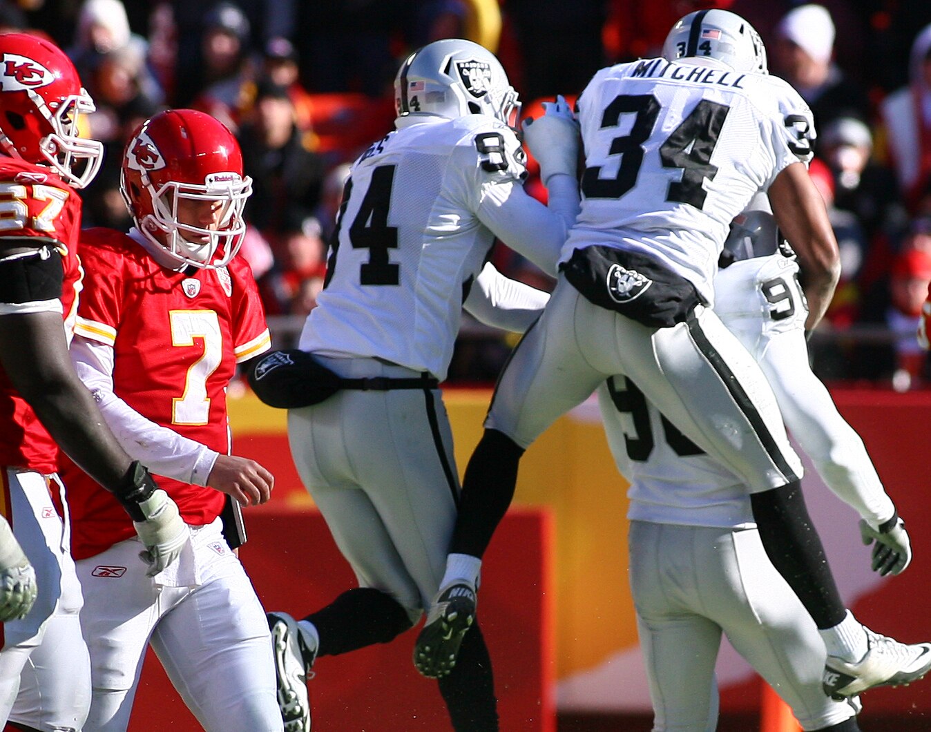 KANSAS CITY, MO - JANUARY 02:  Safety Mike Mitchell #34 and defensive end Jarvis Moss #94 of the Oakland Raiders congratulates linebacker Kamerion Wimbley #96 after a sack in a game against the Kansas City Chiefs at Arrowhead Stadium on January 2, 2011 in
