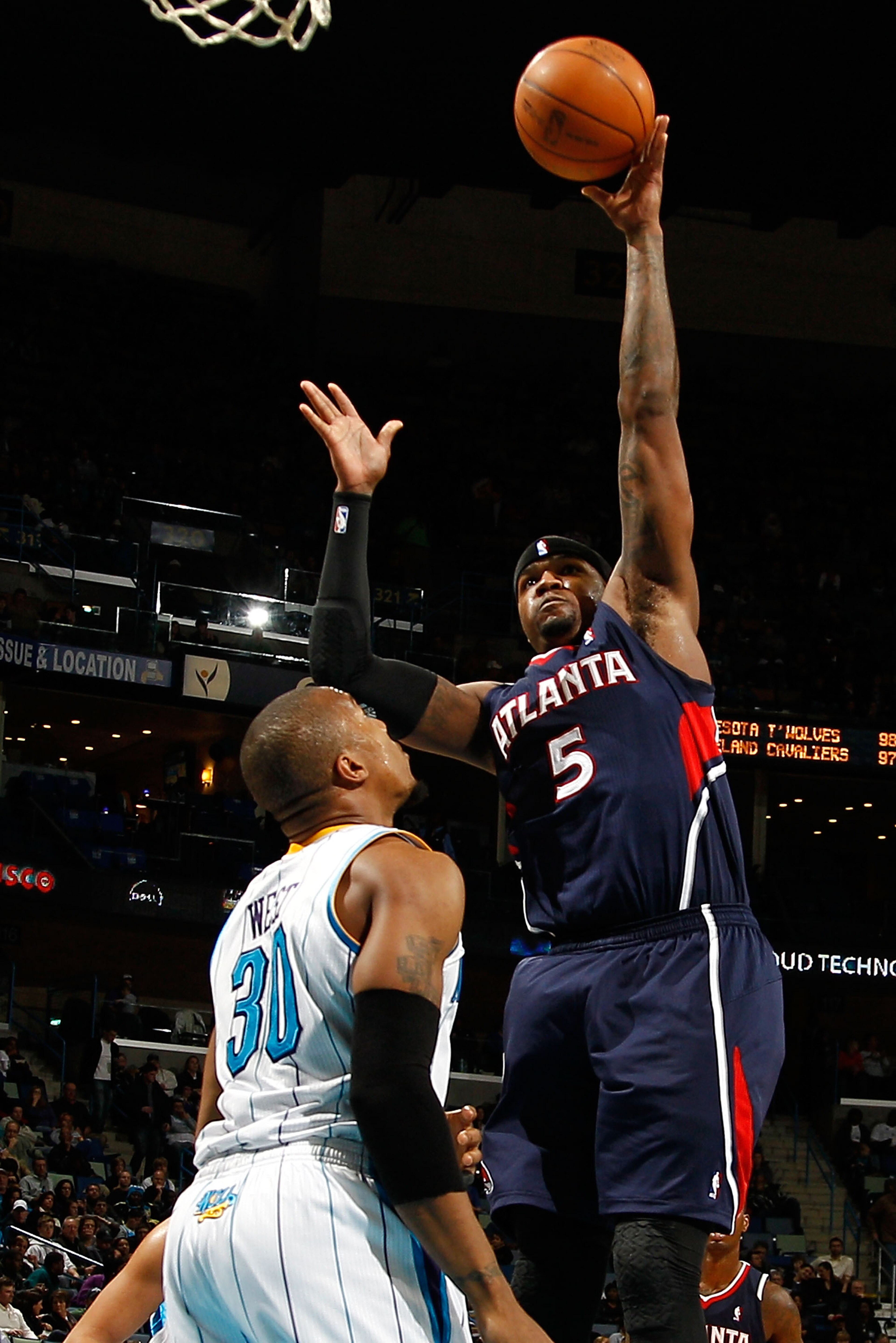 NEW ORLEANS, LA - DECEMBER 26:  Josh Smith #5 of the Atlanta Hawks shoots the ball over David West #30 of the New Orleans Hornets at the New Orleans Arena on December 26, 2010 in New Orleans, Louisiana.  The Hornets defeated the Hawks 93-86.  NOTE TO USER