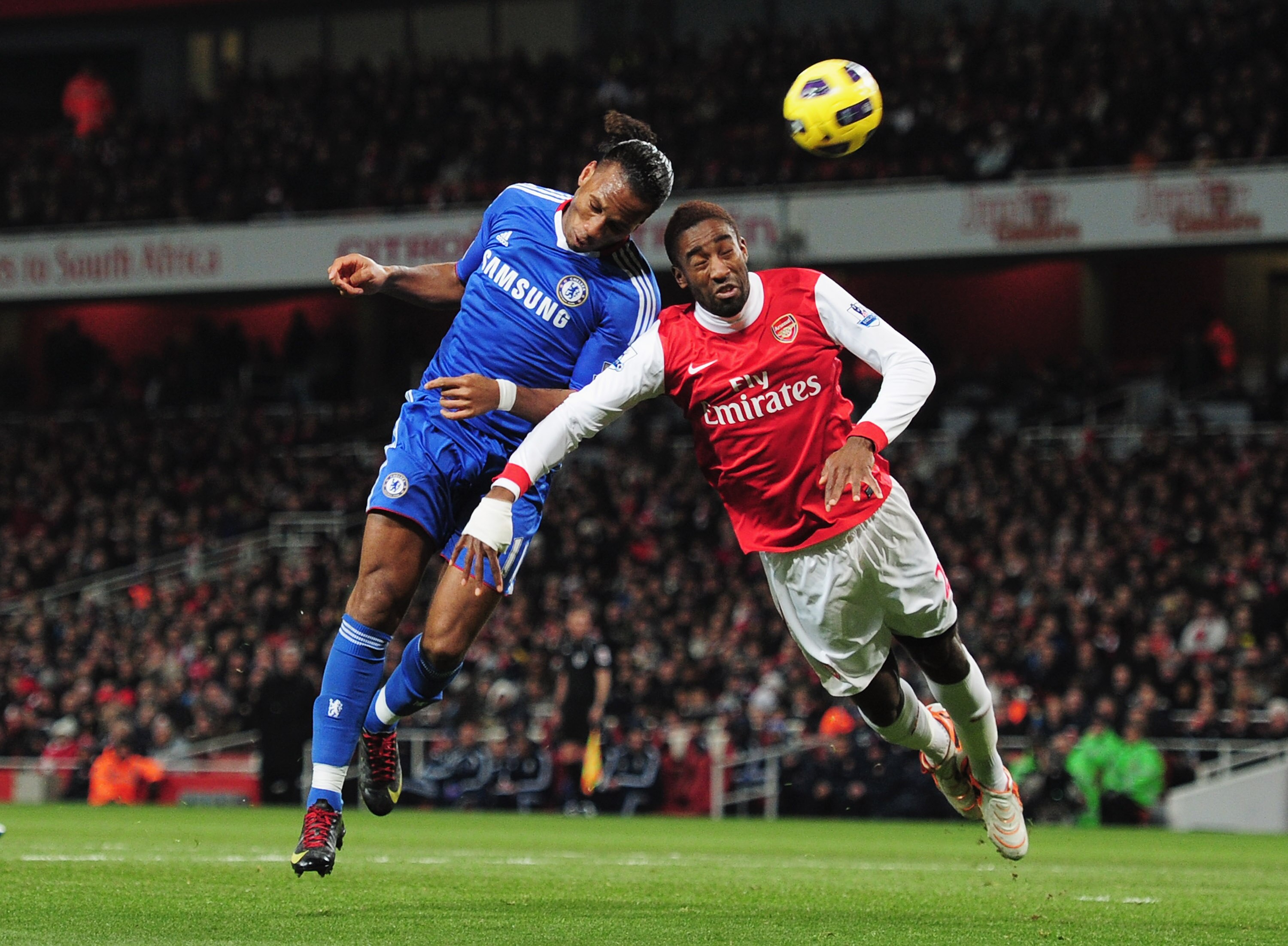LONDON, ENGLAND - DECEMBER 27:  Didier Drogba of Chelsea wins a header against Johan Djourou of Arsenal during the Barclays Premier League match between Arsenal and Chelsea at the Emirates Stadium on December 27, 2010 in London, England.  (Photo by Shaun 