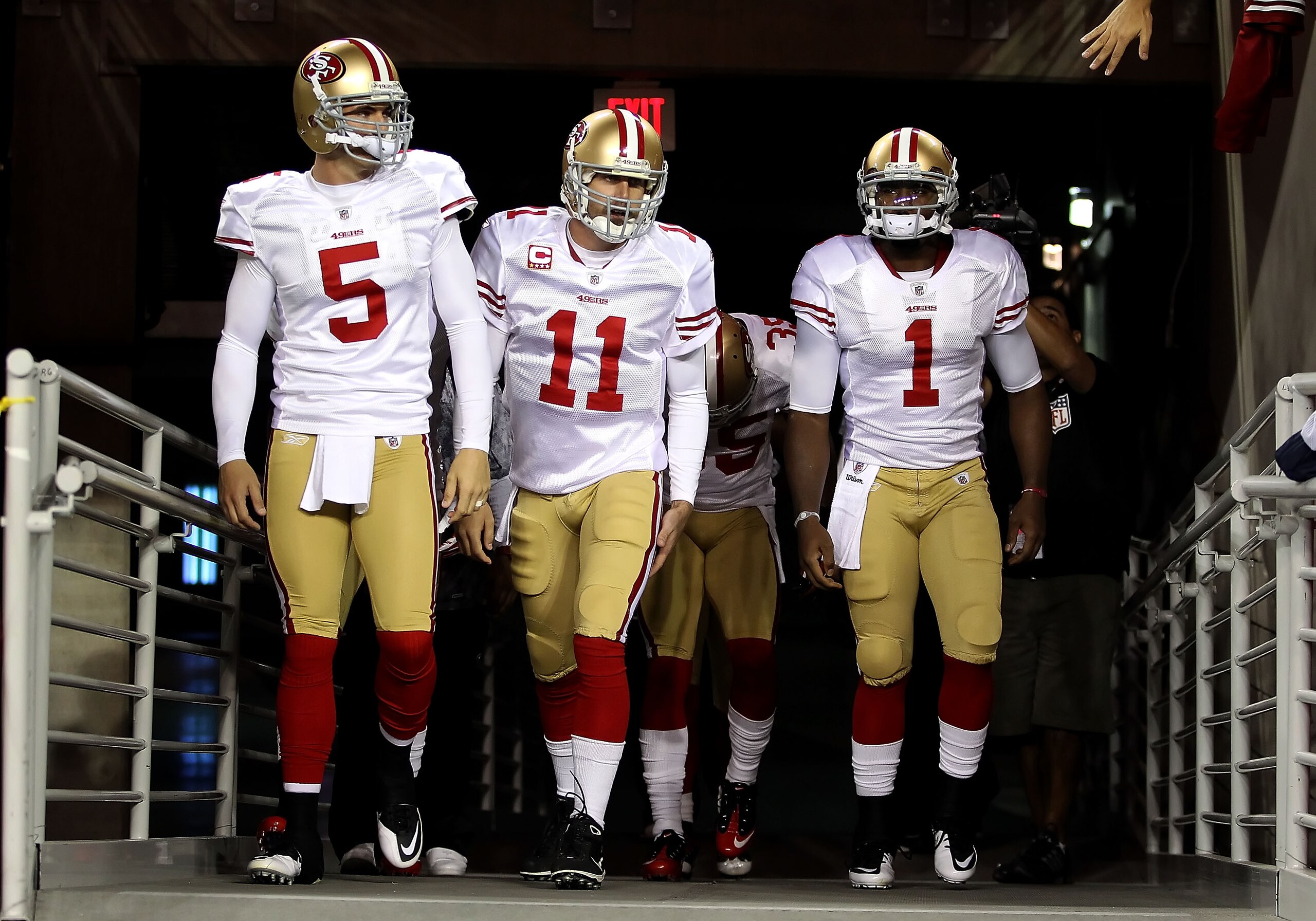 GLENDALE, AZ - NOVEMBER 29:  Quarterbacks David Carr #5, Alex Smith #11 and Troy Smith #1 of the San Francisco 49ers walk out onto the field before the NFL game against the Arizona Cardinals at the University of Phoenix Stadium on November 29, 2010 in Gle