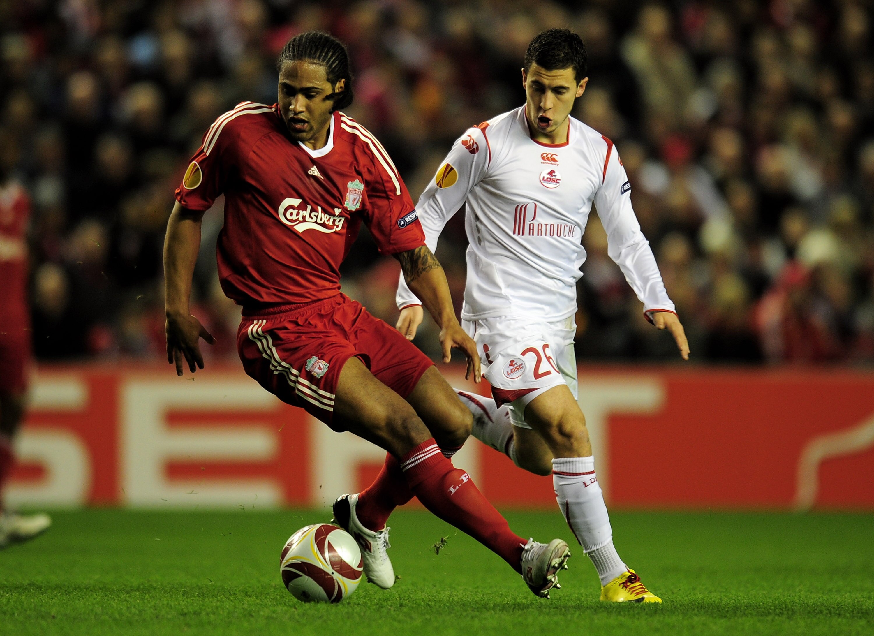 LIVERPOOL, ENGLAND - MARCH 18:  Glen Johnson of Liverpool competes for the ball with Eden Hazard of Lille during the UEFA Europa League Round of 16, second leg match at Anfield on March 18, 2010 in Liverpool, England.  (Photo by Shaun Botterill/Getty Imag