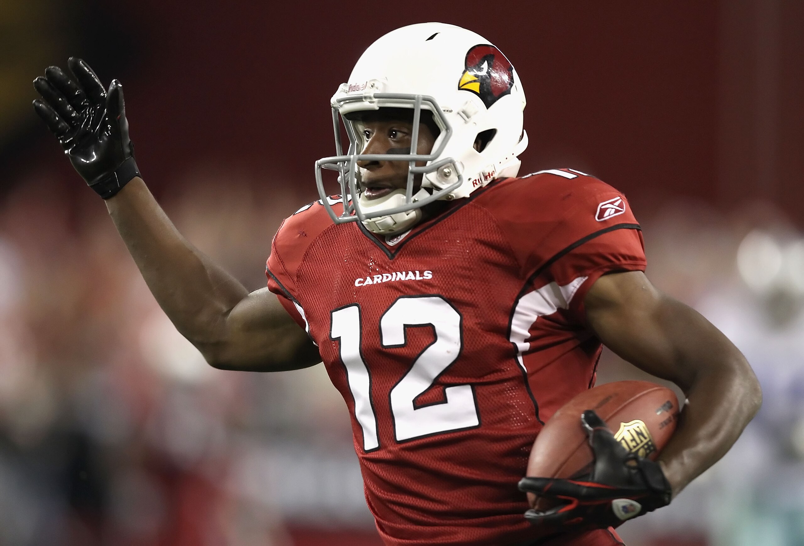 GLENDALE, AZ - DECEMBER 25: Wide receiver Andre Roberts #12 of the Arizona Cardinals runs with the football on a 74 yard touchdown reception against the Dallas Cowboys during the second quarter of the NFL game at the University of Phoenix Stadium on Decem
