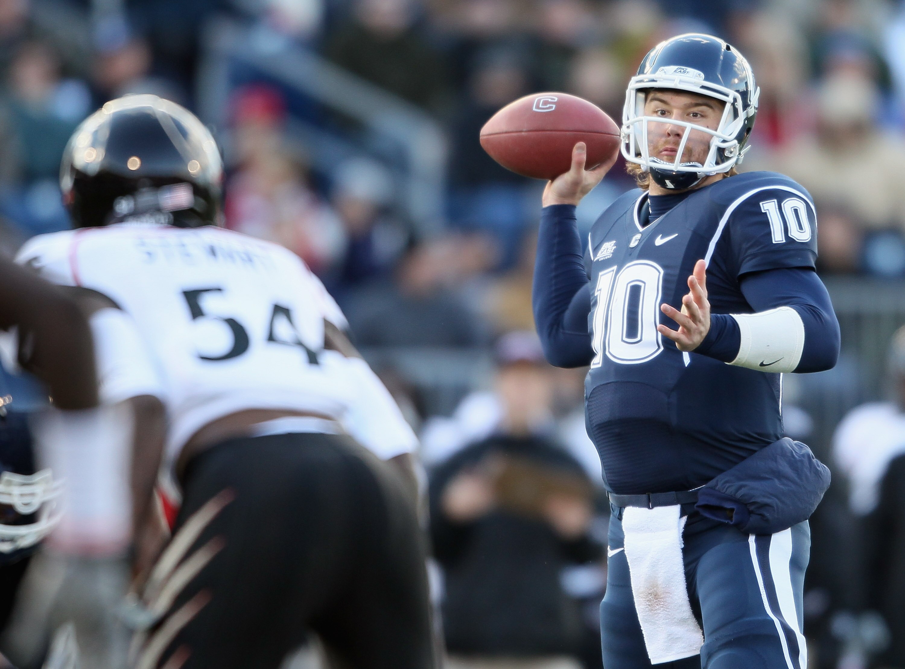 EAST HARTFORD, CT - NOVEMBER 27:  Zach Frazer #10 of the Connecticut Huskies looks to pass under pressure from Walter Stewart #54 of the Cincinnati Bearcats on November 27, 2010 at Rentschler Field in East Hartford, Connecticut.  (Photo by Elsa/Getty Imag