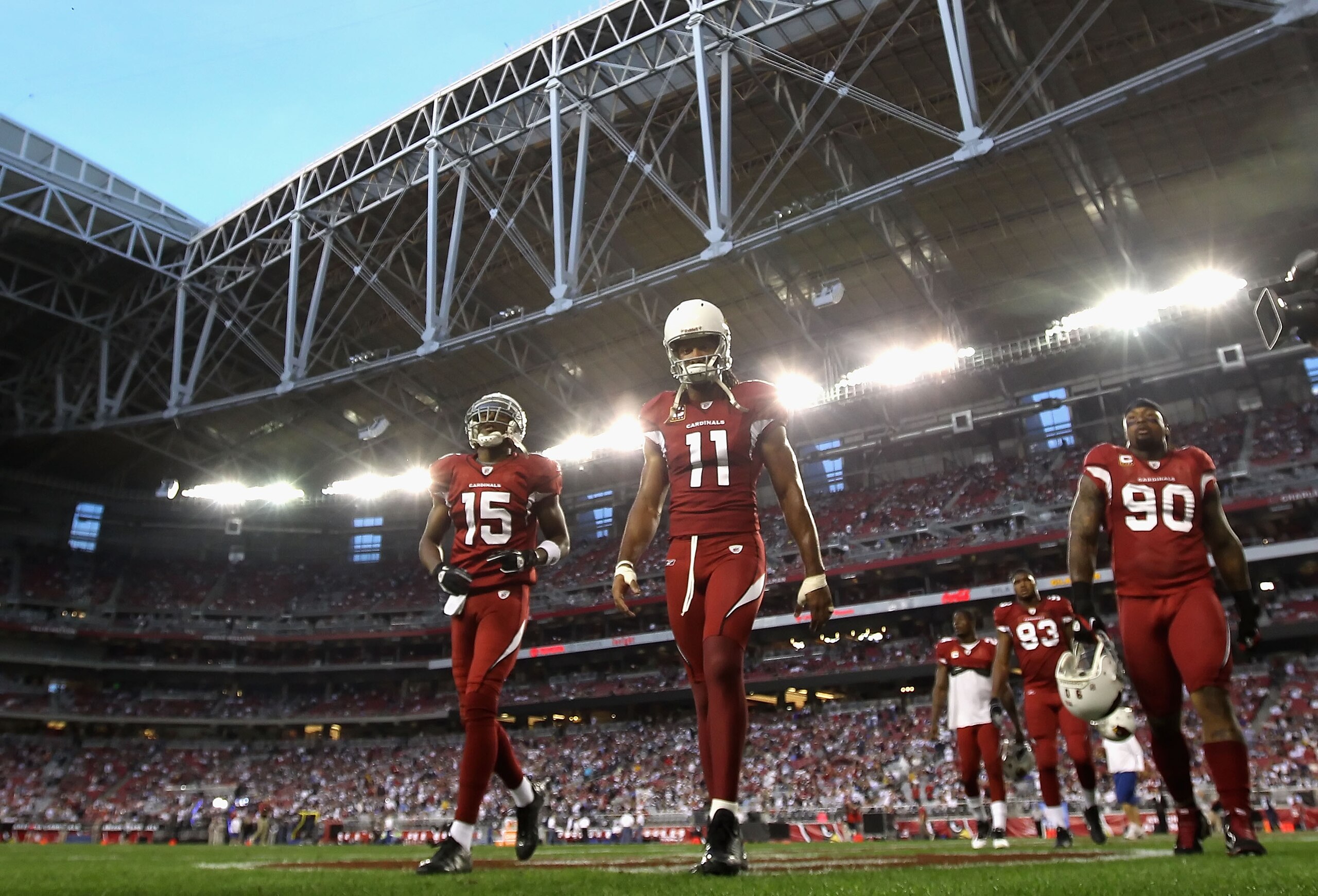 GLENDALE, AZ - DECEMBER 25:  (L-R) Steve Breaston #15, Larry Fitzgerald #11 and Darnell Dockett #90 of the Arizona Cardinals walk off the field following warm ups to the NFL game against the Dallas Cowboys at the University of Phoenix Stadium on December 