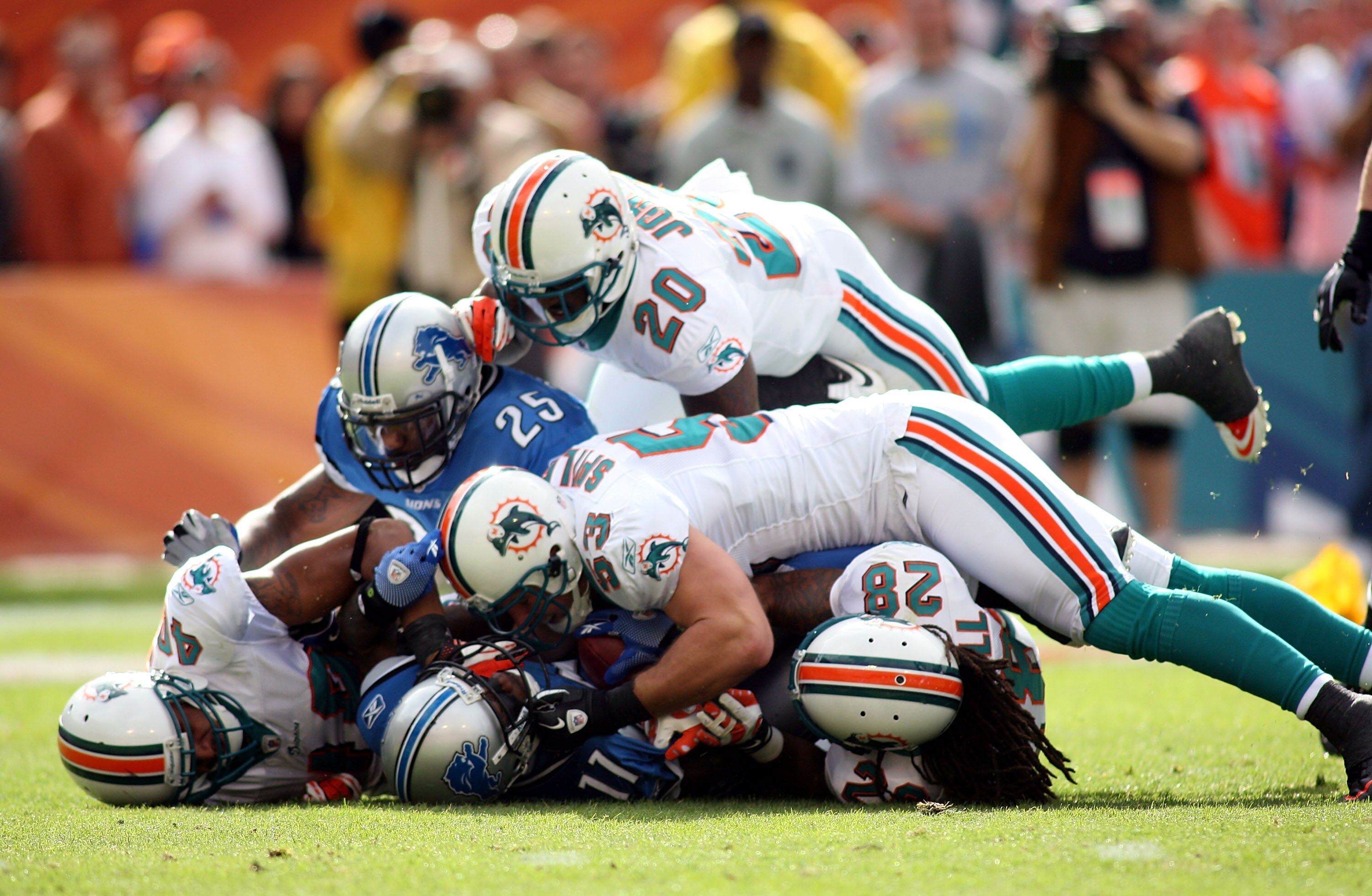 MIAMI - DECEMBER 26: Stefan Logan #11 of the Detroit Lions is gang tackled by the Miami Dolphins at Sun Life Stadium on December 26, 2010 in Miami, Florida.  (Photo by Marc Serota/Getty Images)