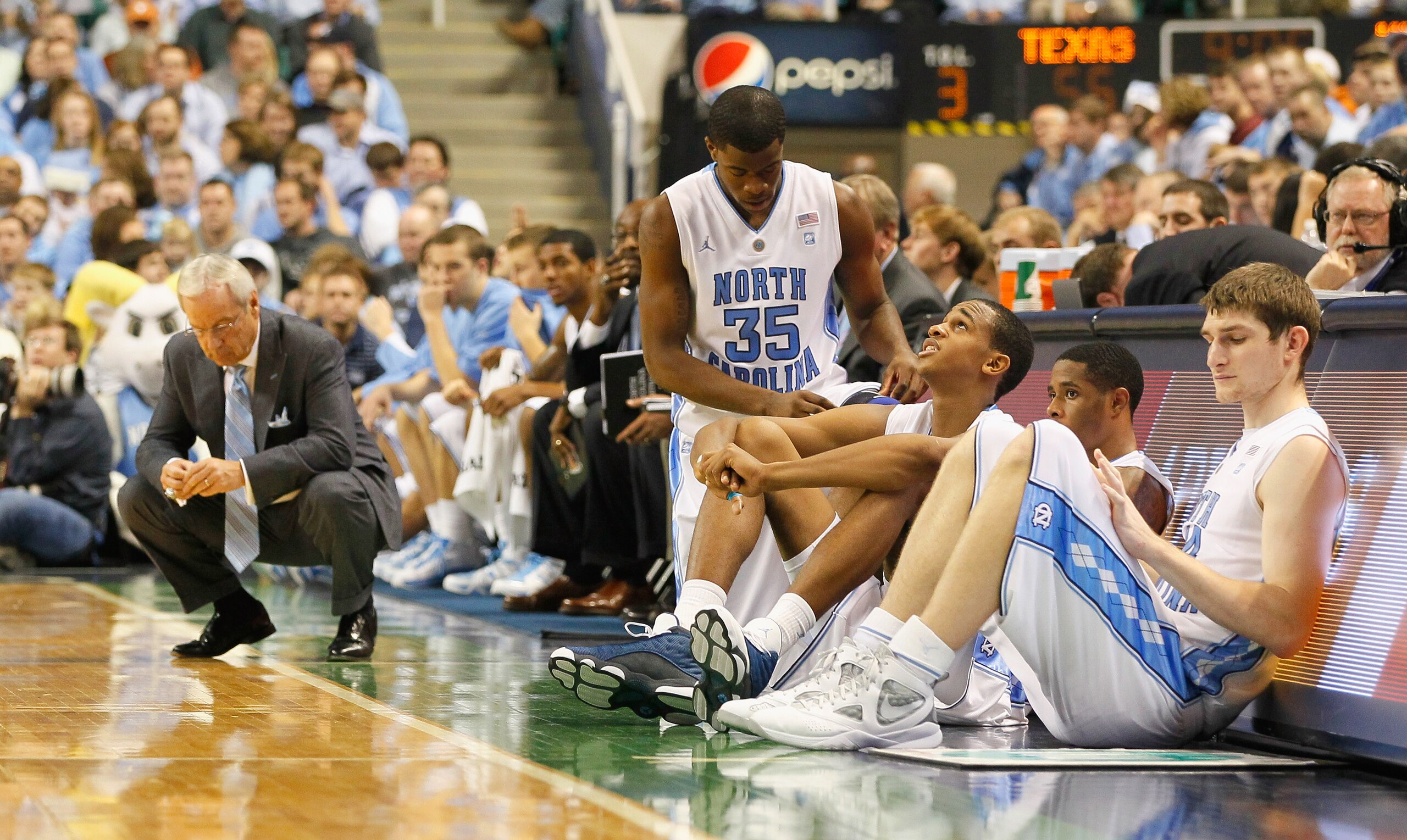 GREENSBORO, NC - DECEMBER 18: Reggie Bullock #35, John Henson #31, Larry Drew II #11 and Tyler Zeller #44 of the North Carolina Tar Heels wait to enter the game as head coach Roy Williams reacts to a basket by the Texas Longhorns at Greensboro Coliseum o GREENSBORO, NC - DECEMBER 18: Reggie Bullock #35, John Henson #31, Larry Drew II #11 and Tyler Zeller #44 of the North Carolina Tar Heels wait to enter the game as head coach Roy Williams reacts to a basket by the Texas Longhorns at Greensboro Coliseum o