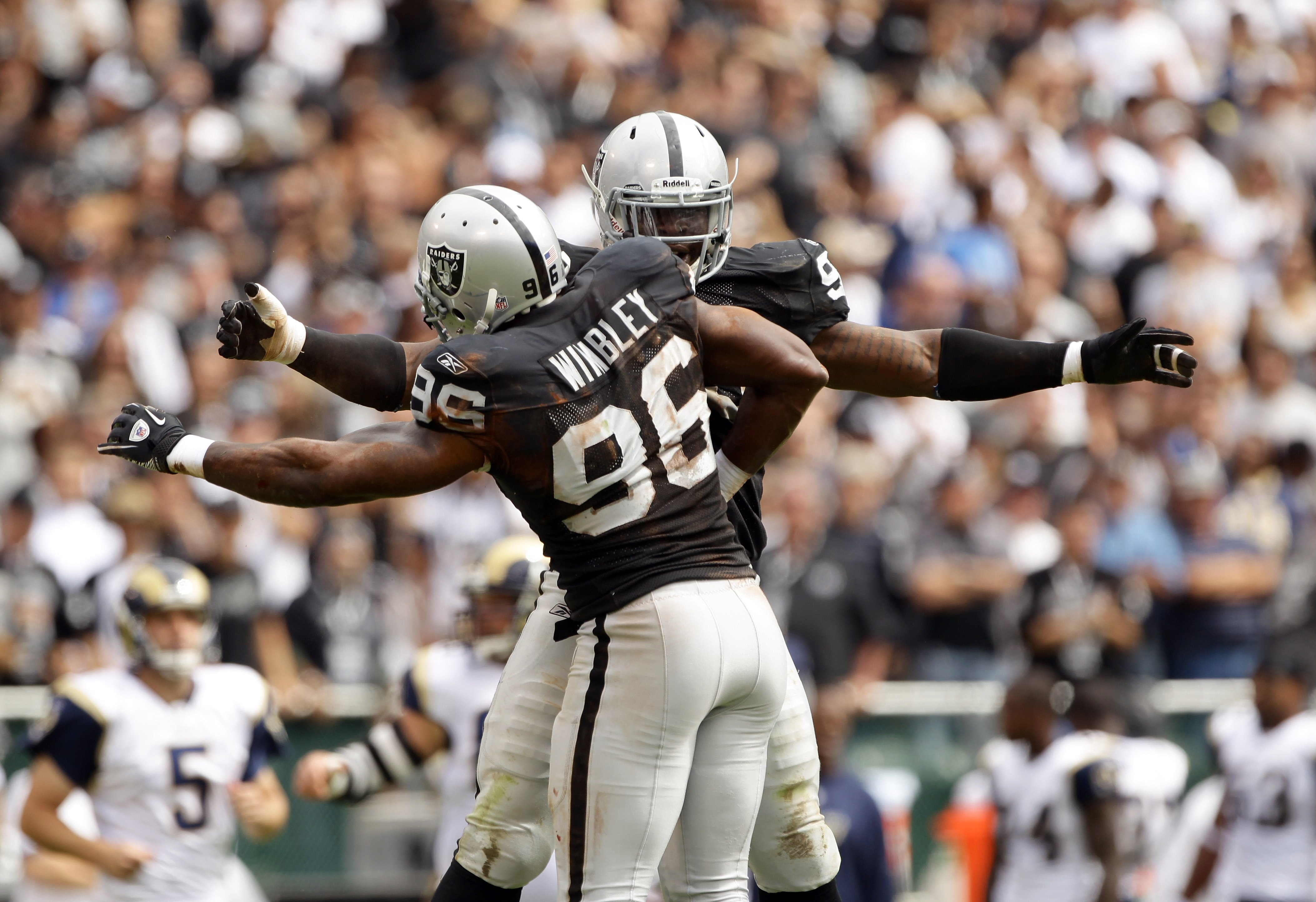 OAKLAND, CA - SEPTEMBER 19:  Lamarr Houston #99 is congratulated by Kamerion Wimbley #96 of the Oakland Raiders after Houston sacked Sam Bradford #8 of the St. Louis Rams at the Oakland-Alameda County Coliseum on September 19, 2010 in Oakland, California.