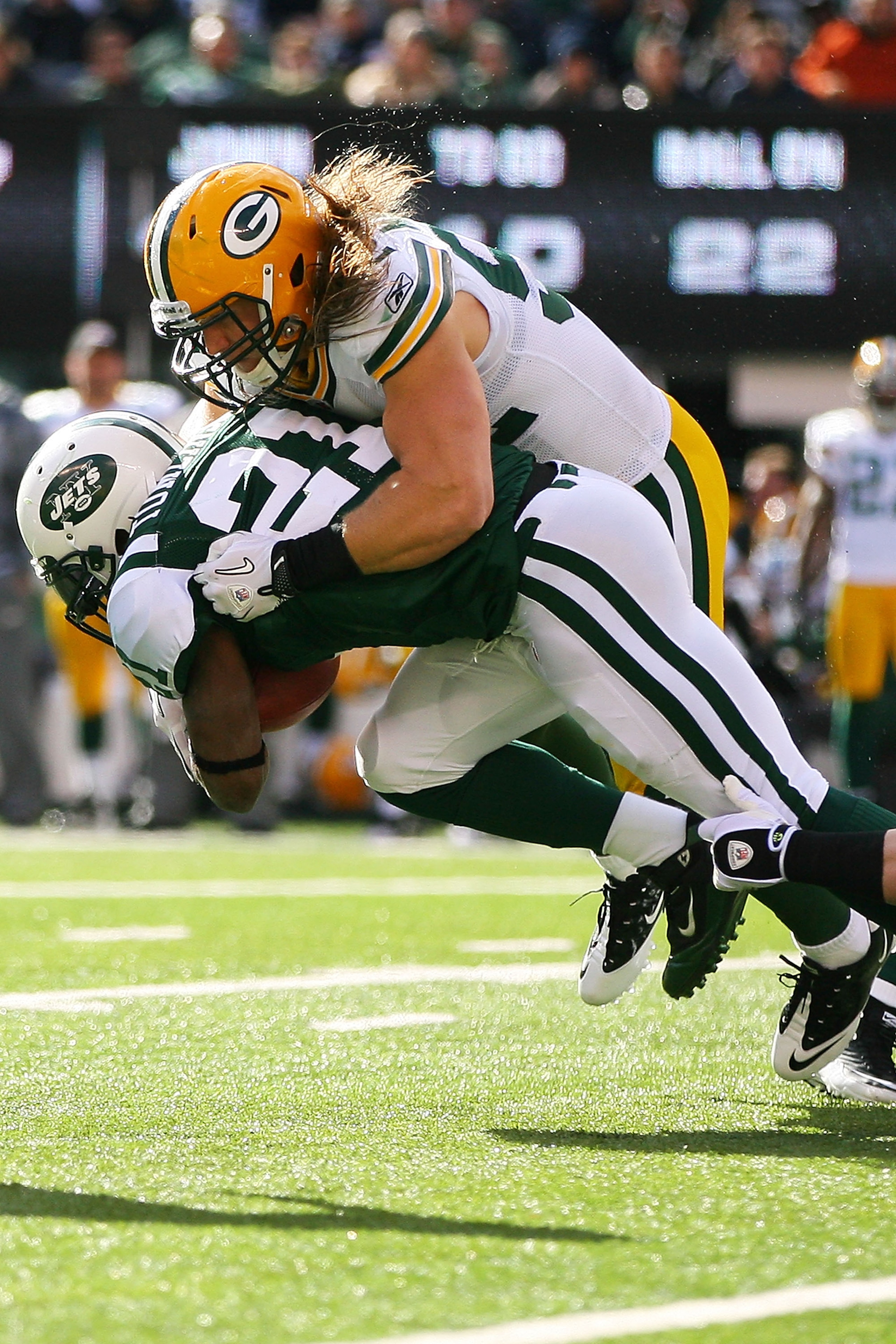 EAST RUTHERFORD, NJ - OCTOBER 31:  Clay Matthews #52 of the Green Bay Packers tackles LaDainian Tomlinson #21 of the New York Jets on October 31, 2010 at the New Meadowlands Stadium in East Rutherford, New Jersey. The Packers defeated  the Jets 9 - 0.  (P