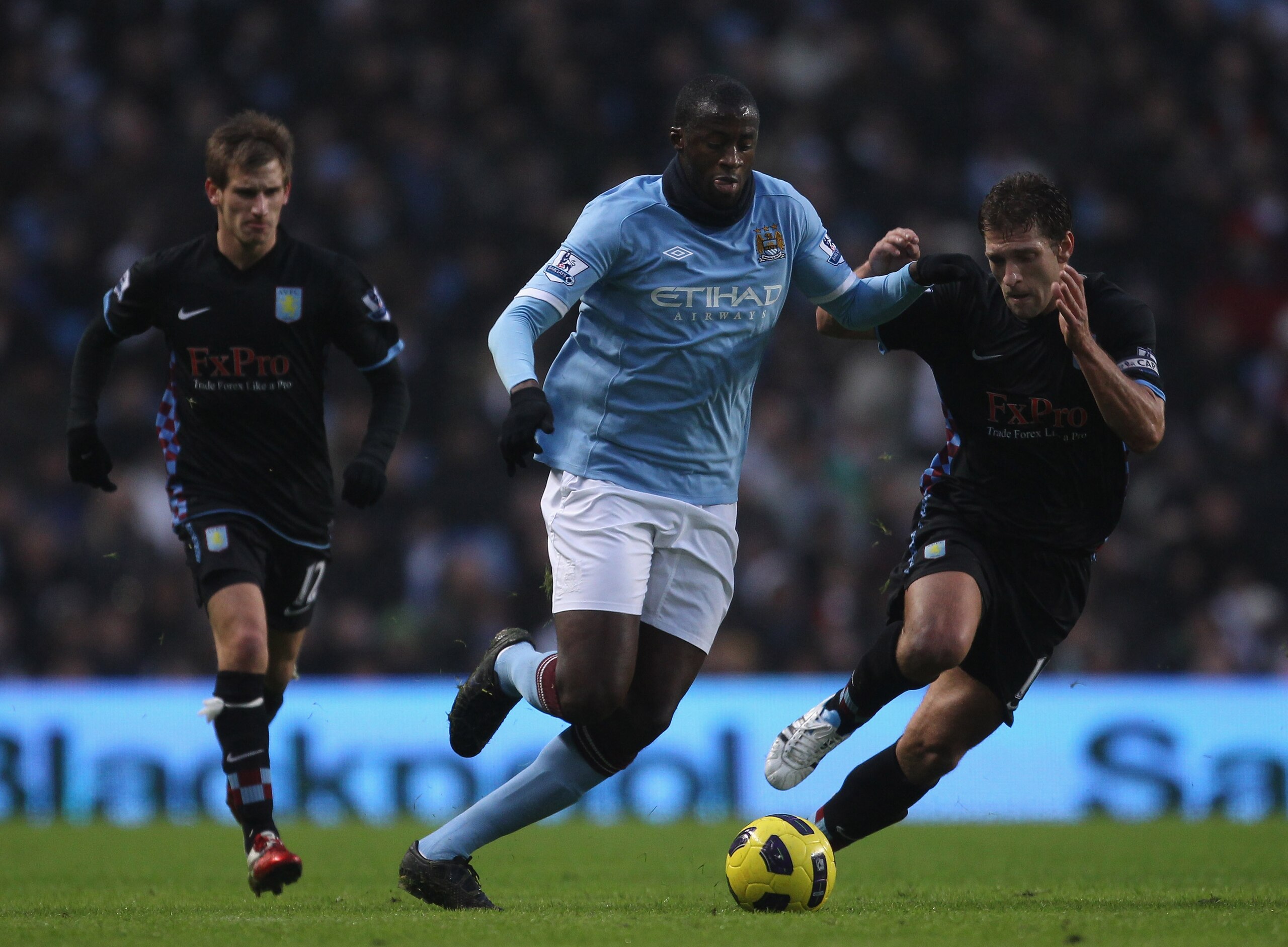 MANCHESTER, ENGLAND - DECEMBER 28:  Yaya Toure of Manchester City holds off a challenge from Stiliyan Petrov of Aston Villa during the Barclays Premier League match between Manchester City and Aston Villa at the City of Manchester Stadium on December 28,