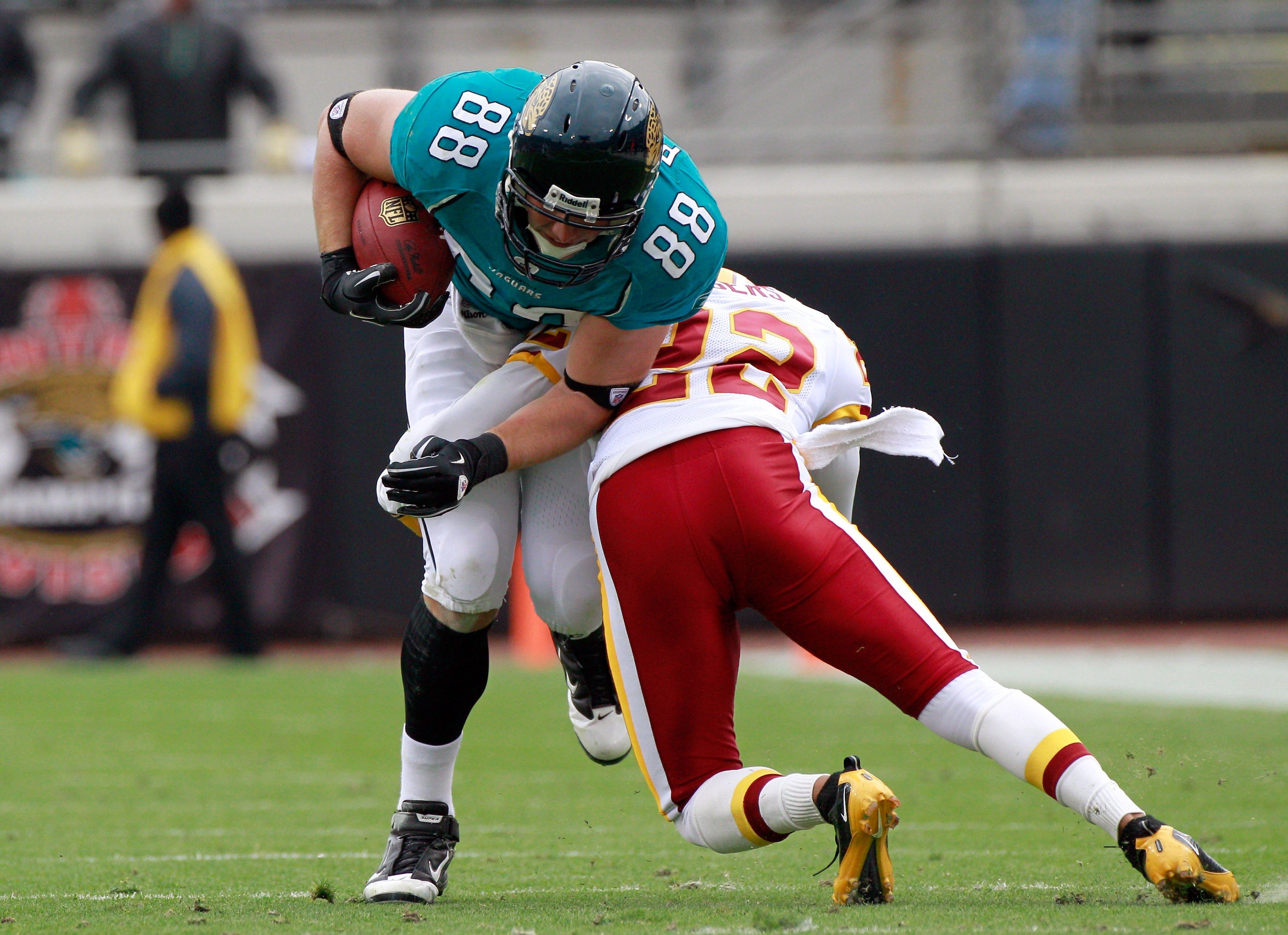 JACKSONVILLE, FL - DECEMBER 26:  Zach Potter #88 of the Jacksonville Jaguars is tackled by Carlos Rogers #22 of the Washington Redskins during the game at EverBank Field on December 26, 2010 in Jacksonville, Florida.  (Photo by Sam Greenwood/Getty Images)