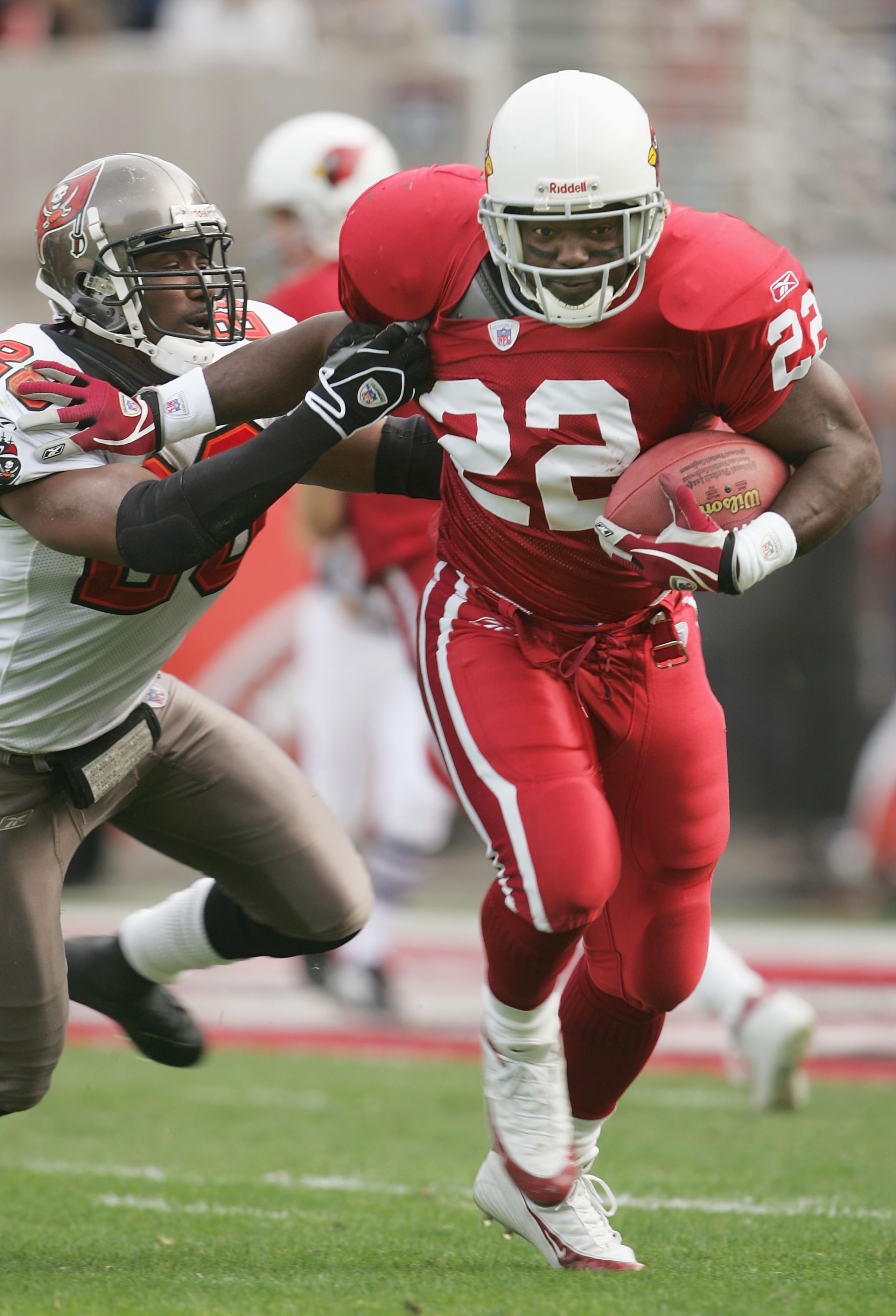 TEMPE, AZ - JANUARY 2:  Runningback Emmitt Smith #22 of the Arizona Cardinals carries the ball under pressure from Dexter Jackson #28 of the Tampa Bay Buccaneers at Sun Devil Stadium on January 2, 2005 in Tempe, Arizona. The Cardinals defeated the Buccane