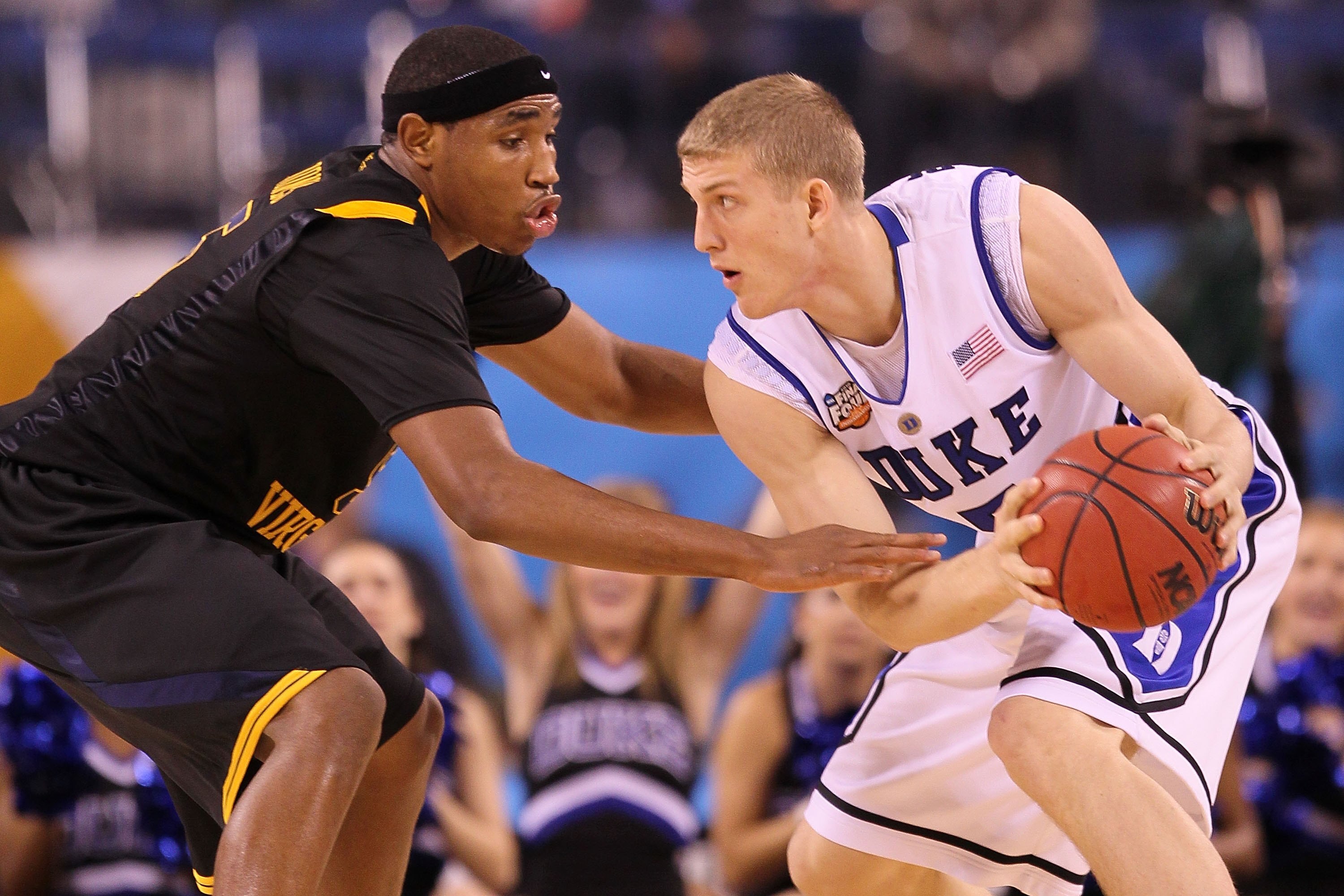 INDIANAPOLIS - APRIL 03:  Mason Plumlee #5 of the Duke Blue Devils with the ball against Kevin Jones #5 of the West Virginia Mountaineers during the National Semifinal game of the 2010 NCAA Division I Men's Basketball Championship at Lucas Oil Stadium on