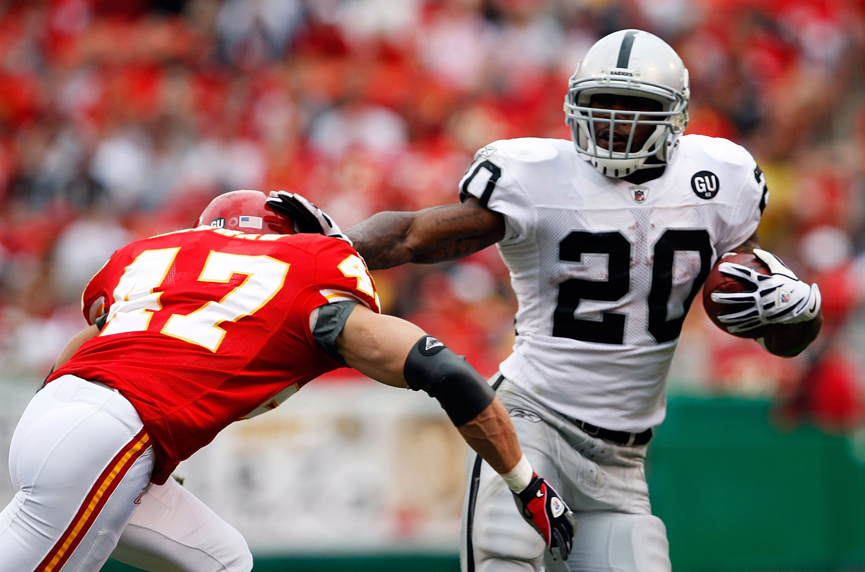 KANSAS CITY, MO - SEPTEMBER 14:  Darren McFadden #20 of the Oakland Raiders carries the ball as Jon McGraw #47 of the Kansas City Chiefs defends during the first half fo the game on September 14, 2008 at Arrowhead Stadium in Kansas City, Missouri.  (Photo