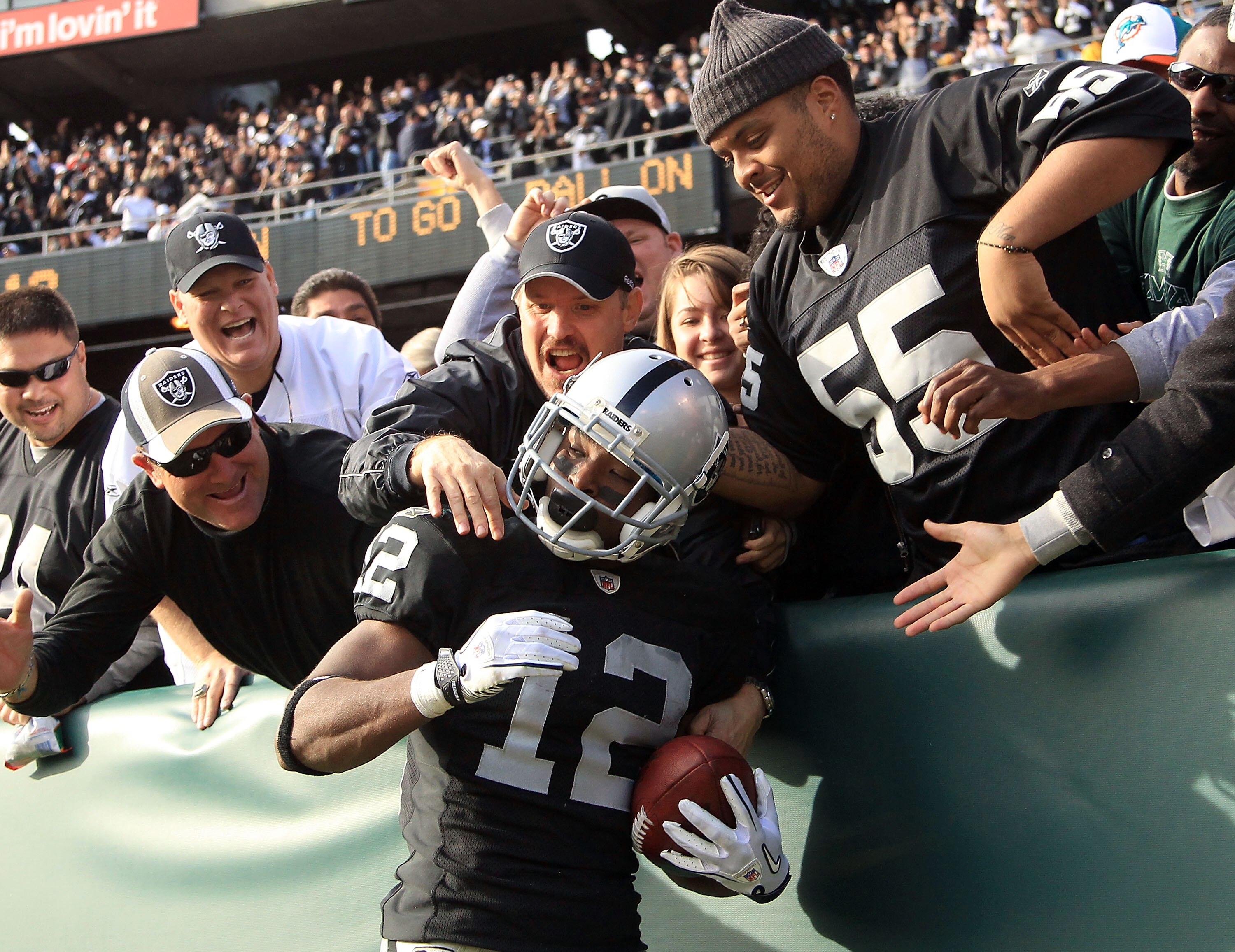 OAKLAND, CA - NOVEMBER 28:  Jacoby Ford #12 of the Oakland Raiders is congratulated by fan after he scored a touchdown against the Miami Dolphins at Oakland-Alameda County Coliseum on November 28, 2010 in Oakland, California.  (Photo by Ezra Shaw/Getty Im