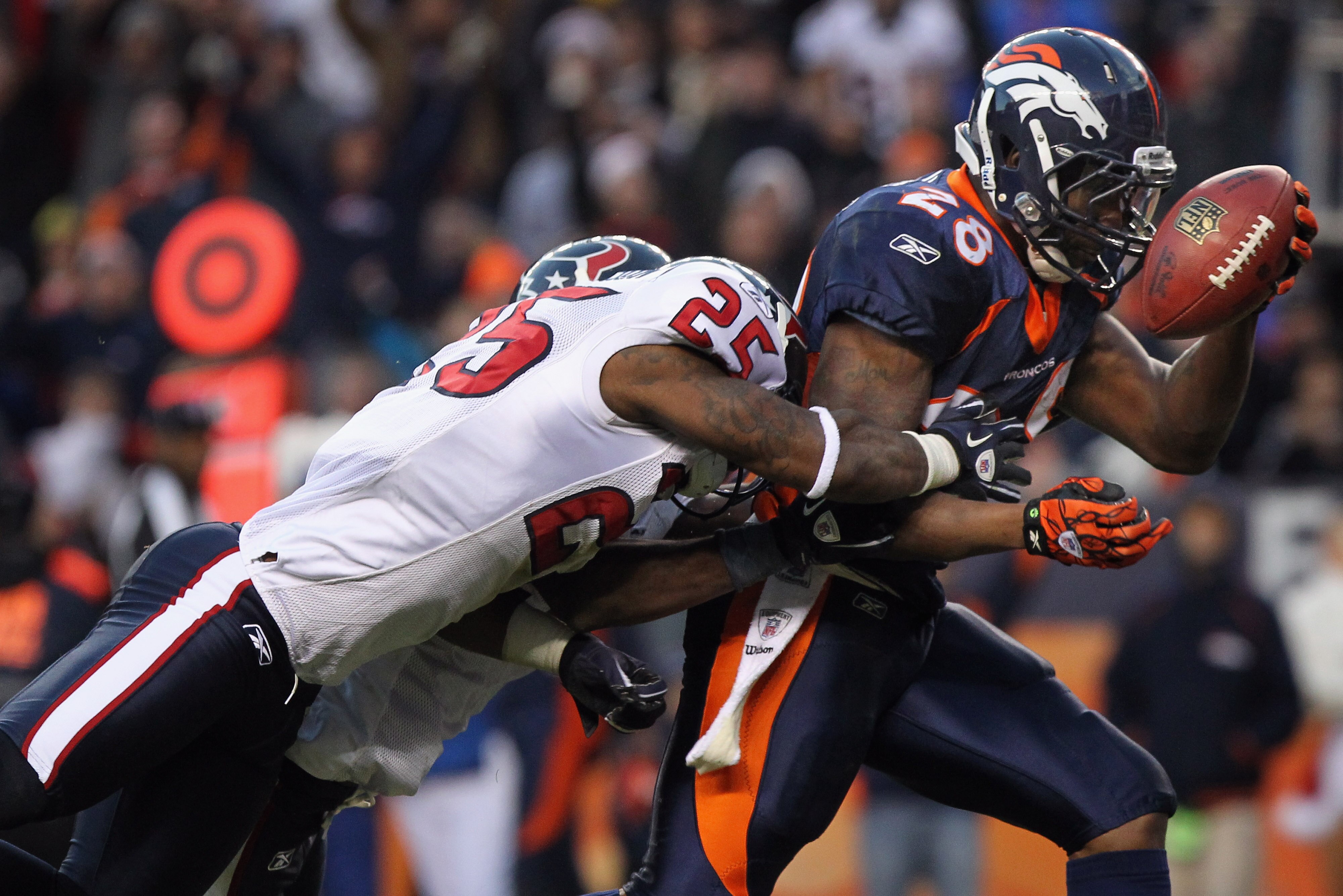 DENVER - DECEMBER 26:  Running back Correll Buckhalter #28 of the Denver Broncos sheds cornerback Kareem Jackson #25 and free safety Troy Nolan #33 of the Houston Texas as he goes into the endzone on a 23 yard pass reception for a fourth quarter touchdown