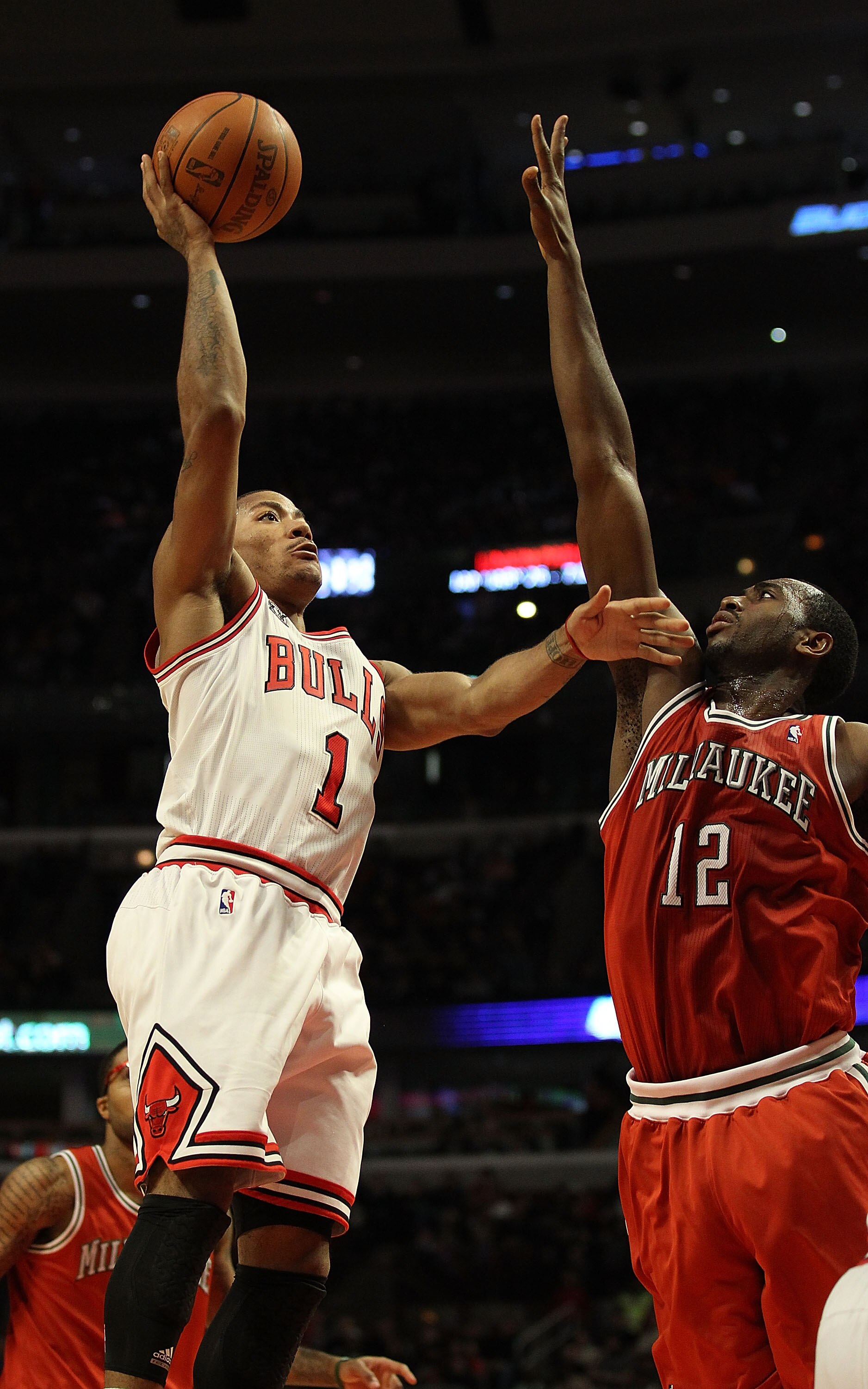 CHICAGO, IL - DECEMBER 28: Derrick Rose #1 of the Chicago Bulls shoots over Luc Mbah a Moute #12 of the Milwaukee Bucks at the United Center on December 28, 2010 in Chicago, Illinois. The Bulls defeated the Bucks 90-77. NOTE TO USER: User expressly acknow